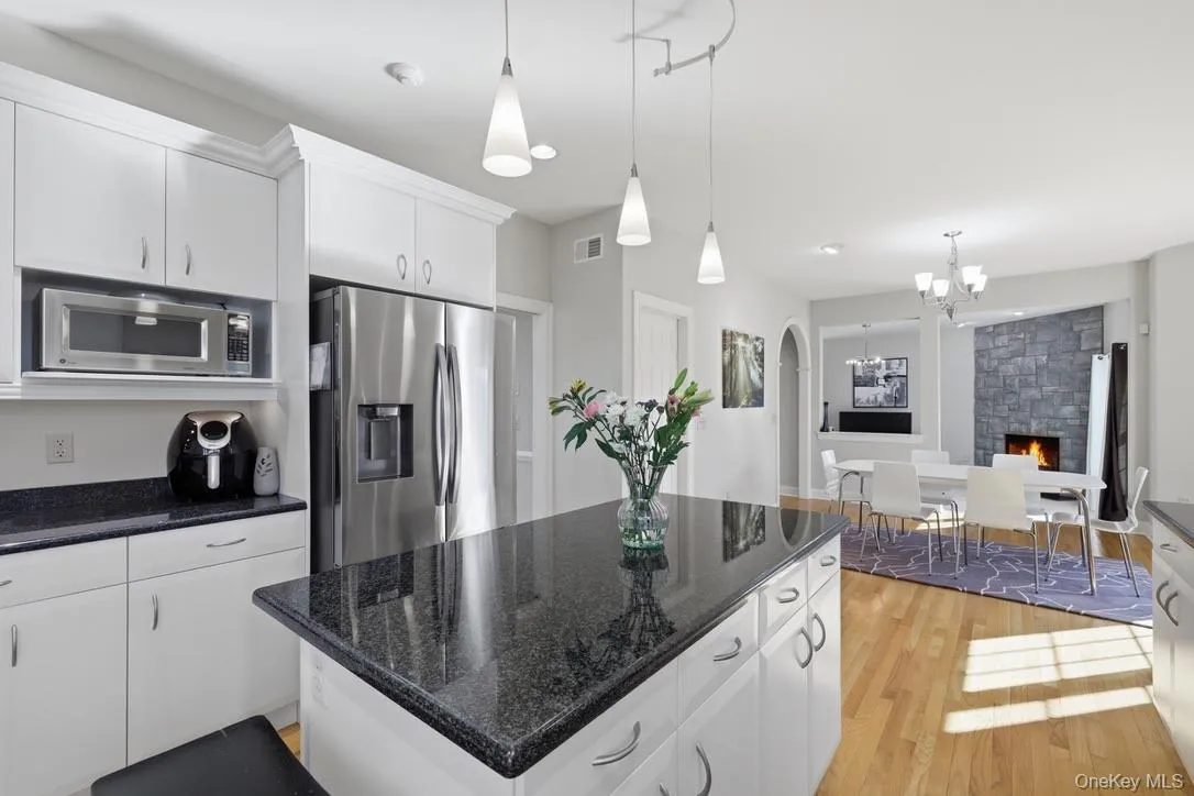 Timeless white cabinetry and granite counters grace the kitchen. Timeless white cabinetry and granite counters grace the kitchen.