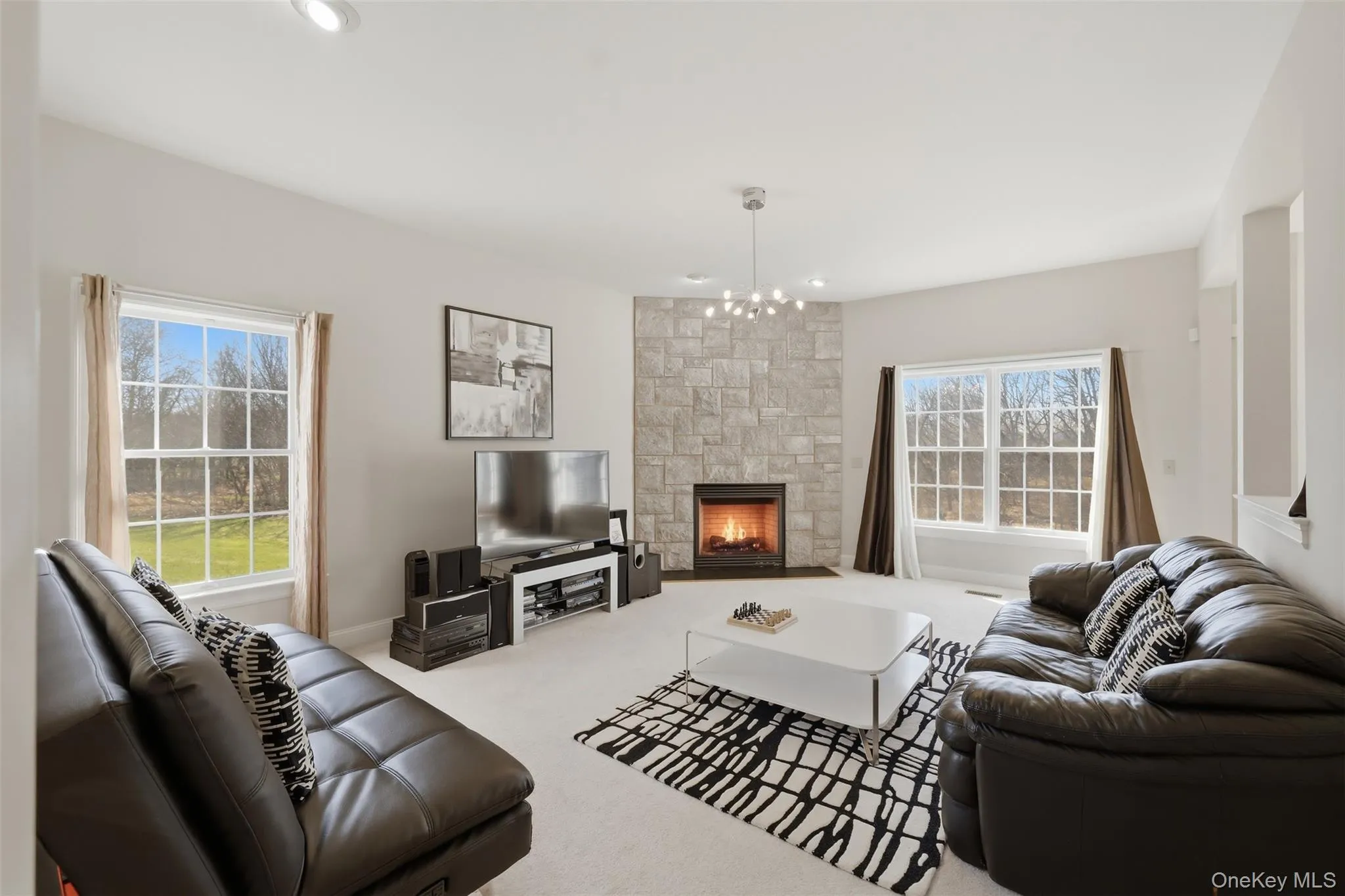 Family room with gas fireplace and plenty of natural light Family room with gas fireplace and plenty of natural light