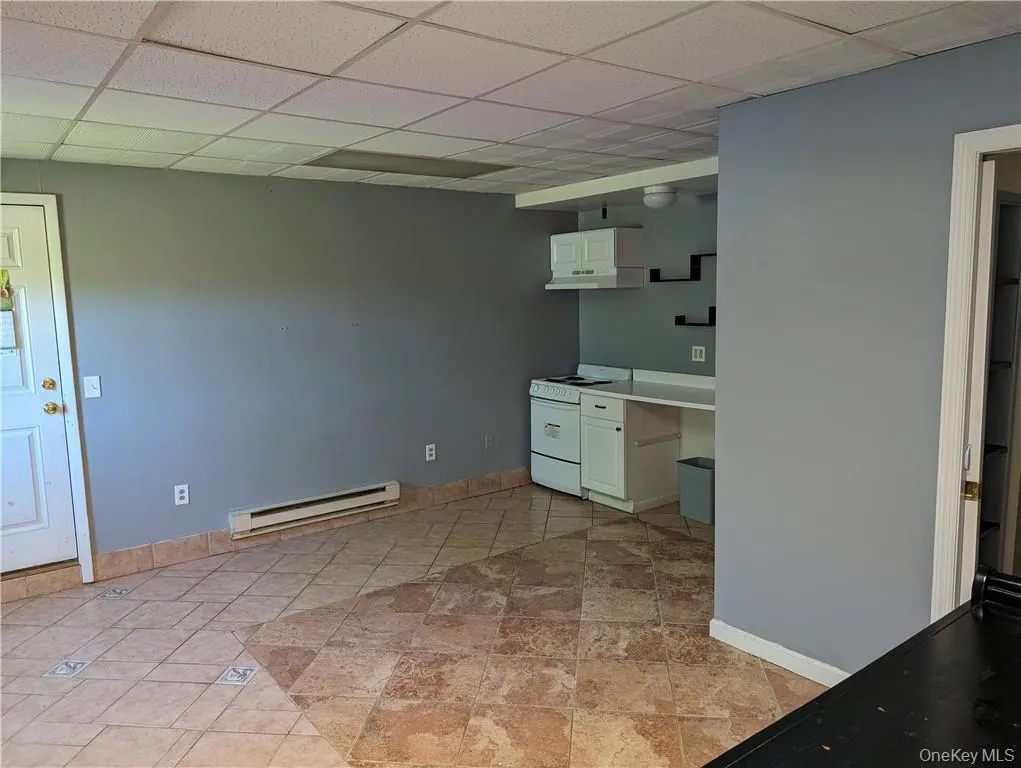 Beauty salon Unfurnished office with a paneled ceiling, a baseboard heating unit, and light tile floors Beauty salon Unfurnished office with a paneled ceiling, a baseboard heating unit, and light tile floors