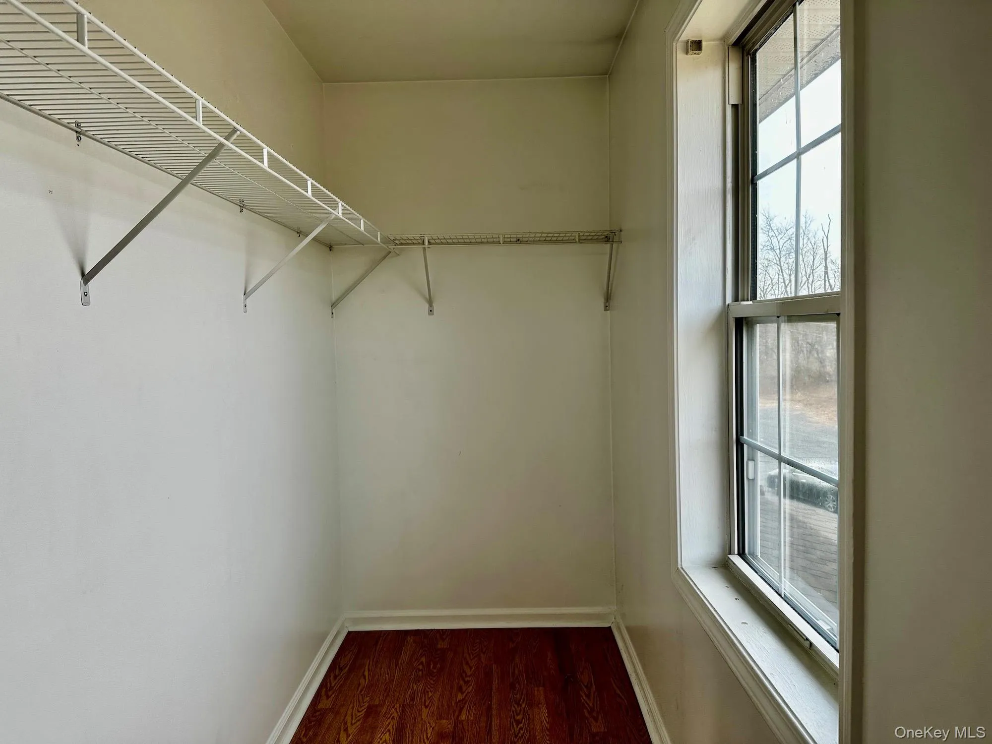 Spacious closet with wood finished floors Spacious closet with wood finished floors