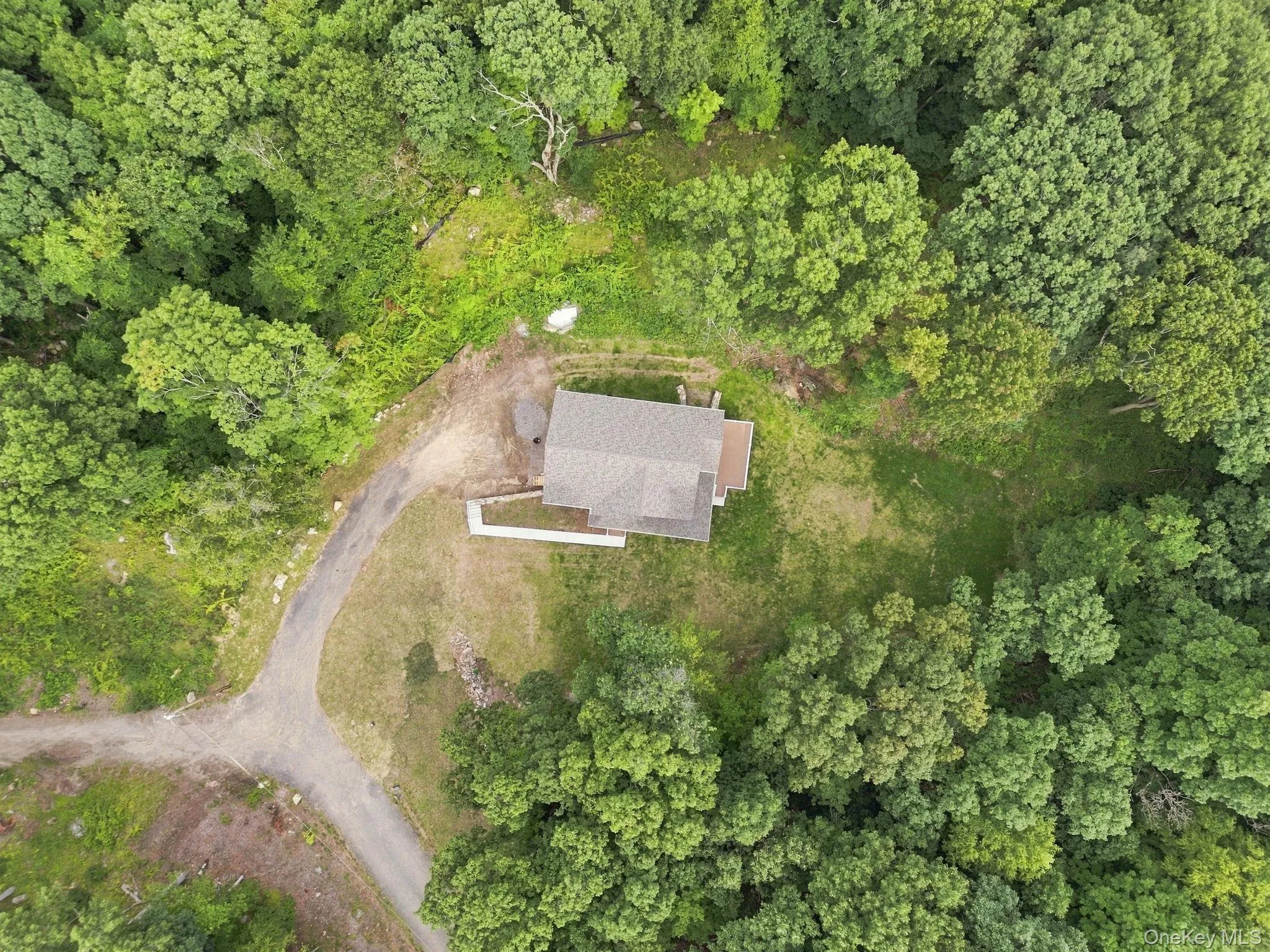 Aerial view showcases the property’s exceptional privacy, lush greenery, and serene natural setting, creating a peaceful country retreat surrounded by nature. Aerial view showcases the property’s exceptional privacy, lush greenery, and serene natural setting, creating a peaceful country retreat surrounded by nature.