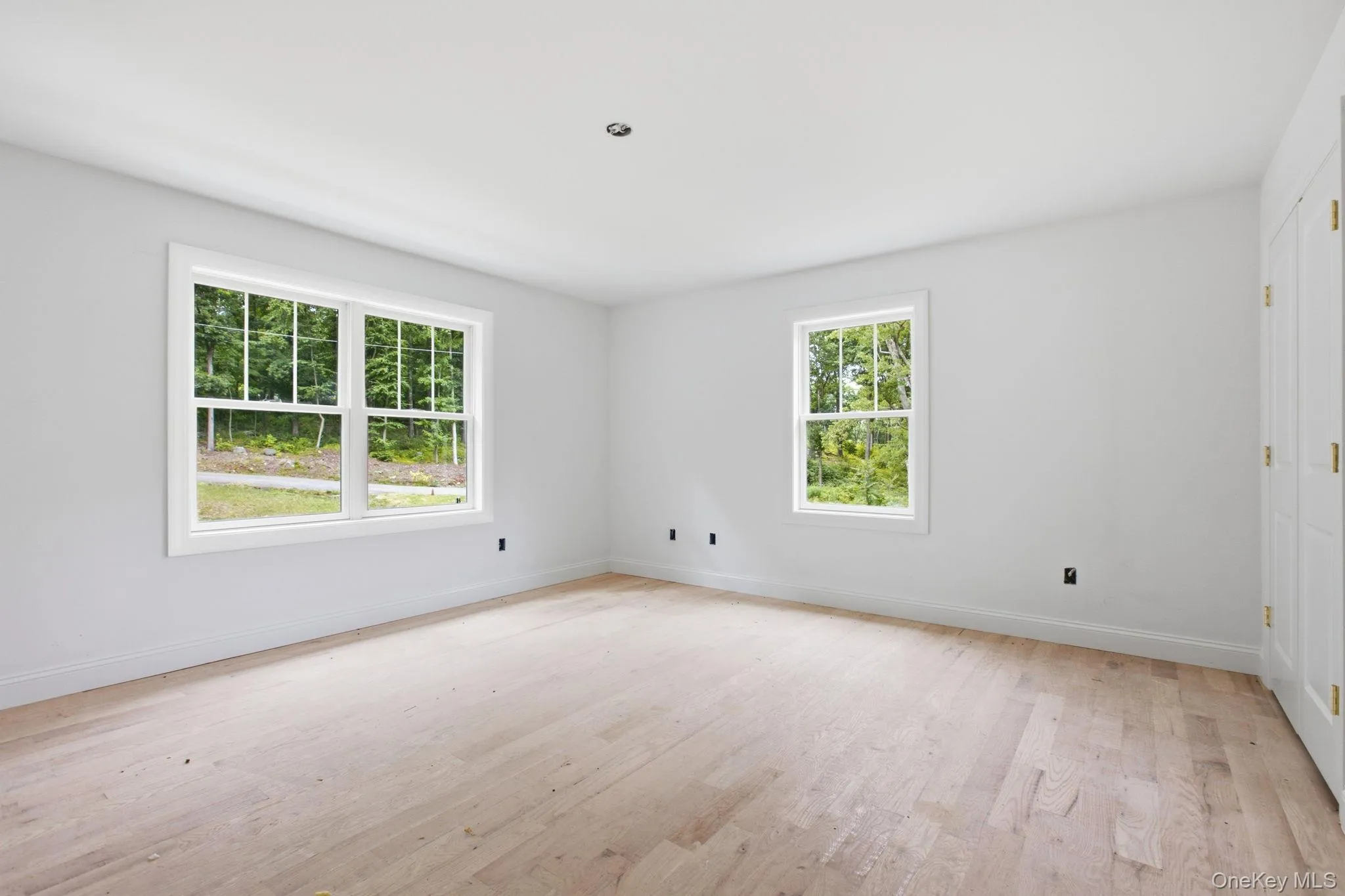 Bedroom two features hardwood floors and a large closet, offering a comfortable and versatile space Bedroom two features hardwood floors and a large closet, offering a comfortable and versatile space