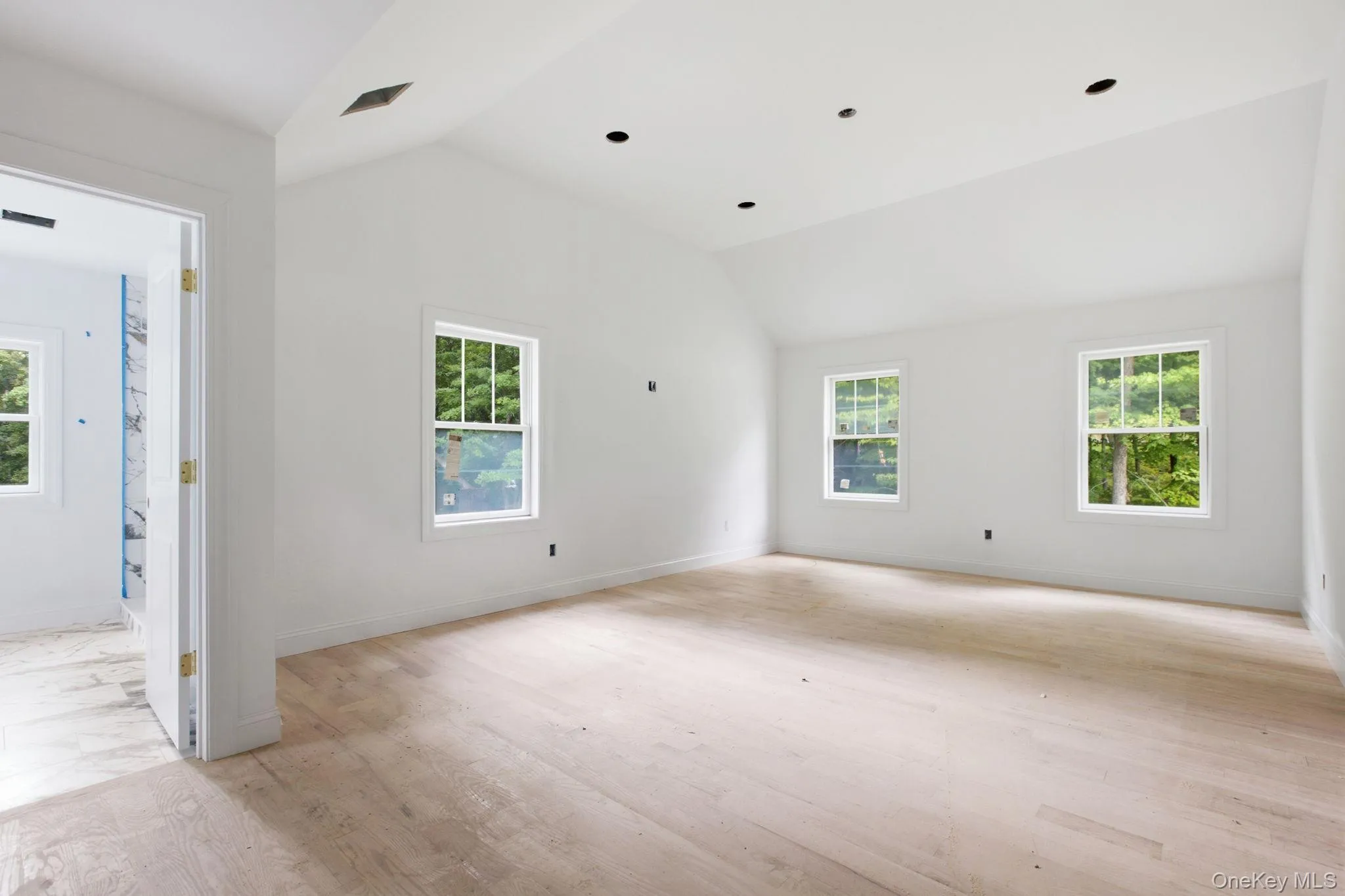 Privately positioned primary bedroom featuring high ceilings, hardwood floors, and a walk-in closet, creating a peaceful and refined retreat. Privately positioned primary bedroom featuring high ceilings, hardwood floors, and a walk-in closet, creating a peaceful and refined retreat.