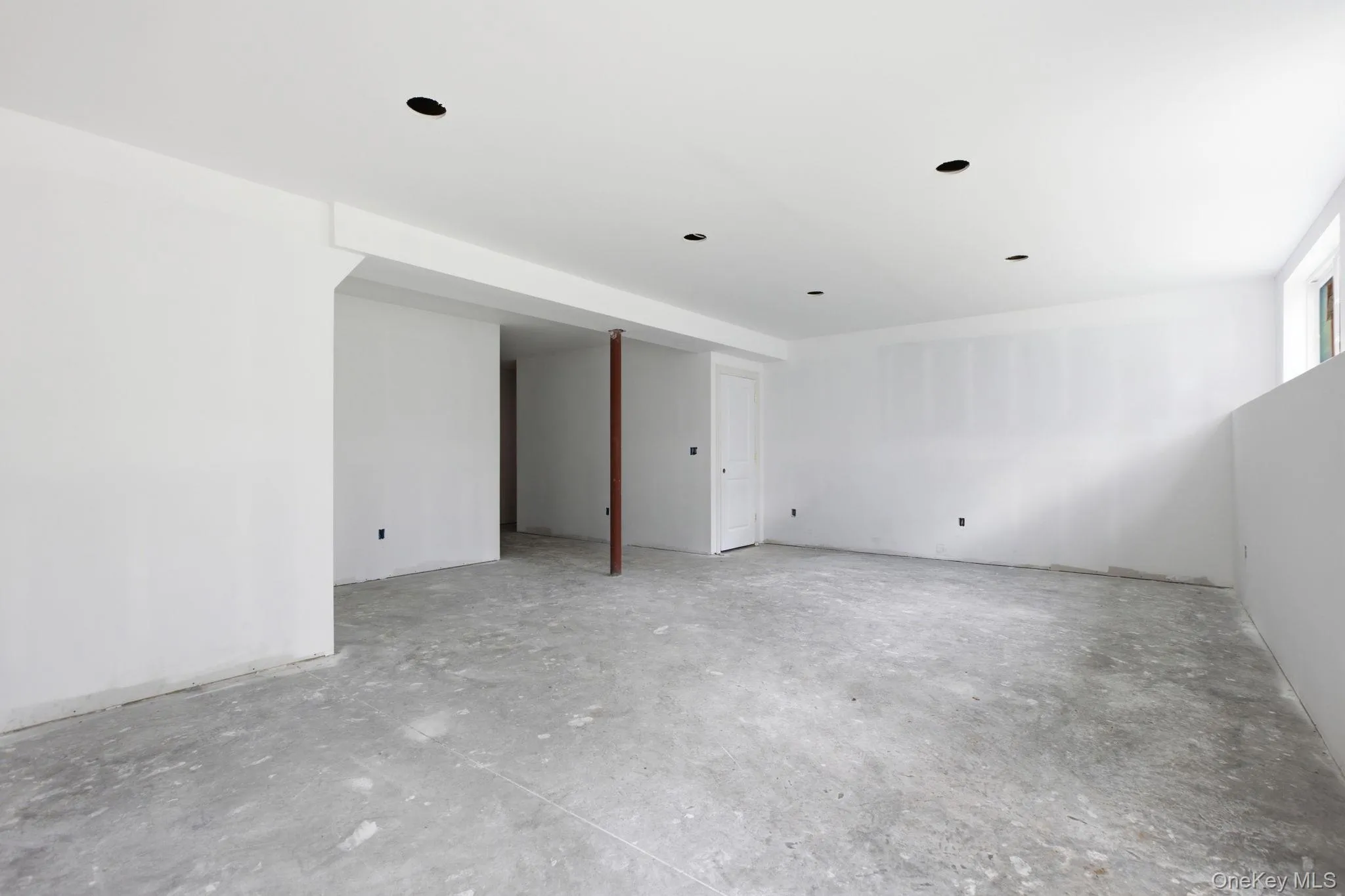The finished lower level features recessed lighting and ample space for a future wet bar, creating an inviting setting for entertaining, recreation, and casual gatherings. The finished lower level features recessed lighting and ample space for a future wet bar, creating an inviting setting for entertaining, recreation, and casual gatherings.