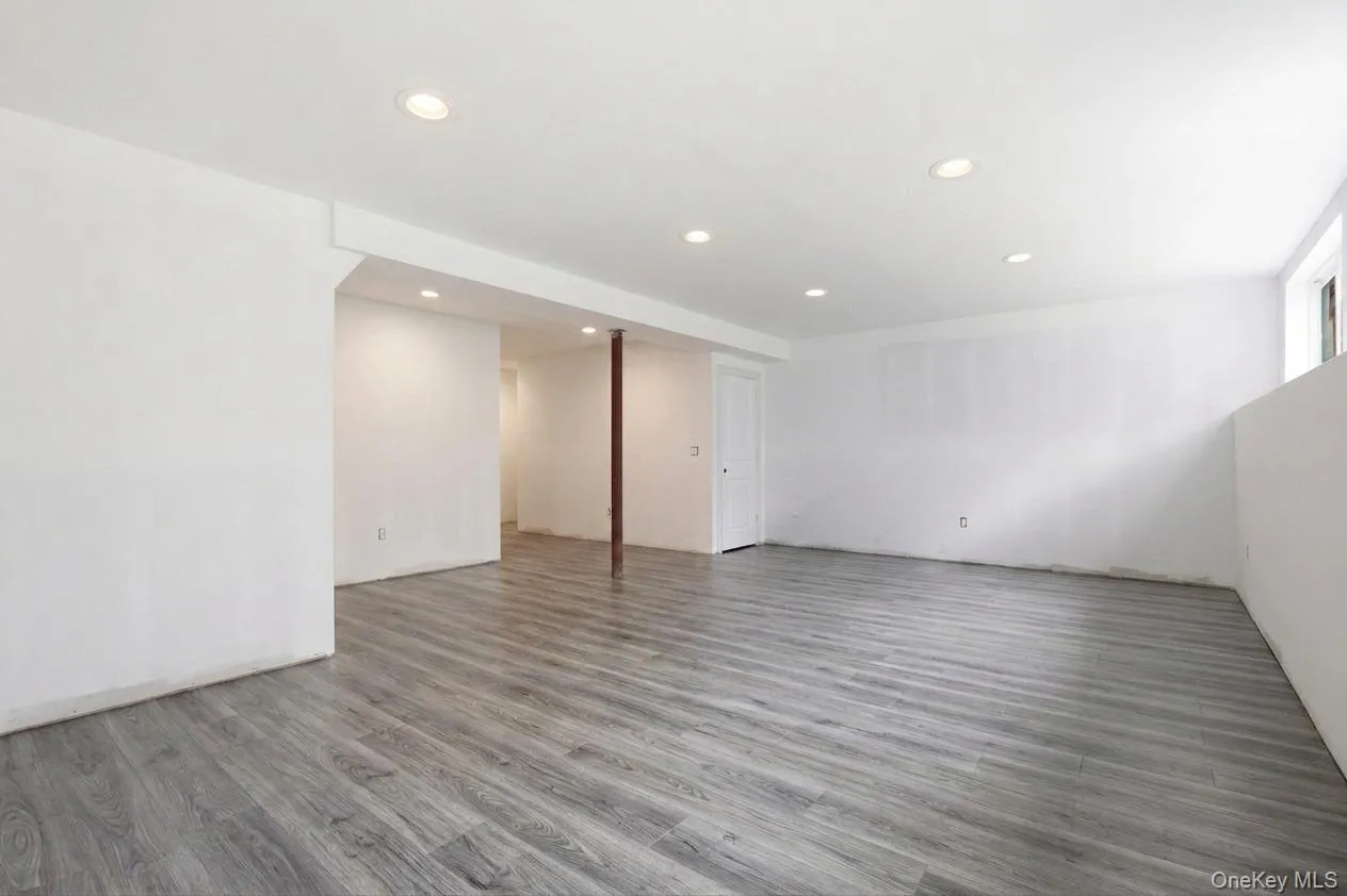 Virtually shown with completed recessed lighting and gray waterproof luxury vinyl flooring, illustrating how the finished lower level can blend style, durability, and everyday functionality. Virtually shown with completed recessed lighting and gray waterproof luxury vinyl flooring, illustrating how the finished lower level can blend style, durability, and everyday functionality.