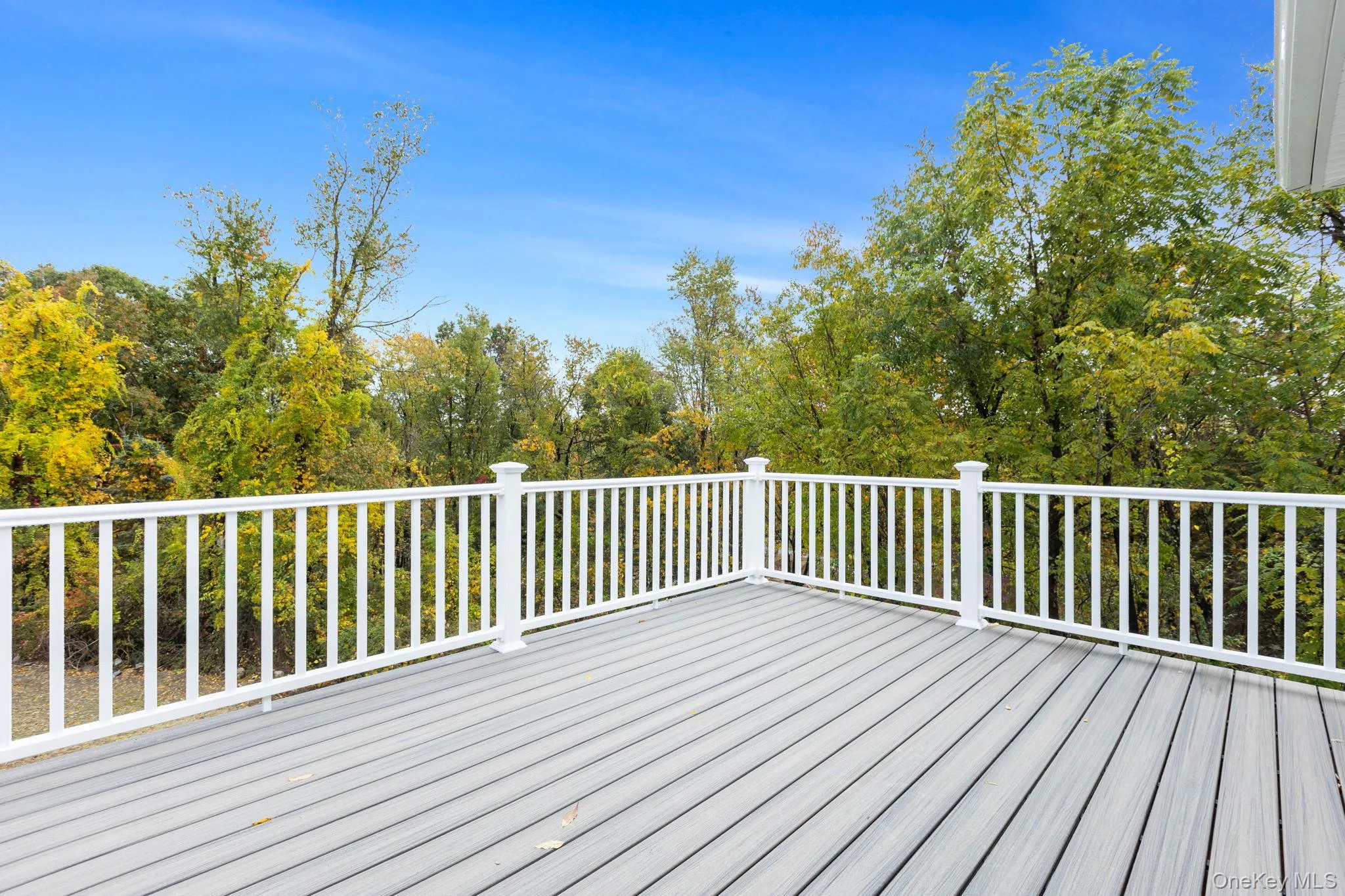 Demonstrates previously built deck for sister home with trek decking and white vinyl railing. Actual completed deck may vary from photo Demonstrates previously built deck for sister home with trek decking and white vinyl railing. Actual completed deck may vary from photo