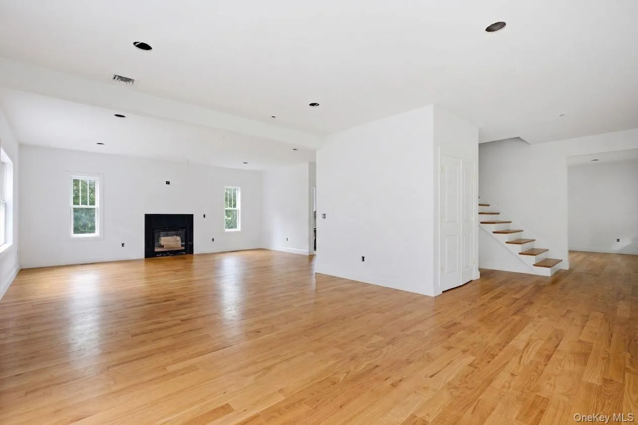 Virtually staged to illustrate the family room’s finished potential with warm-stained hardwood floors; buyers still have the opportunity to select a different stain color to suit their style. Virtually staged to illustrate the family room’s finished potential with warm-stained hardwood floors; buyers still have the opportunity to select a different stain color to suit their style.