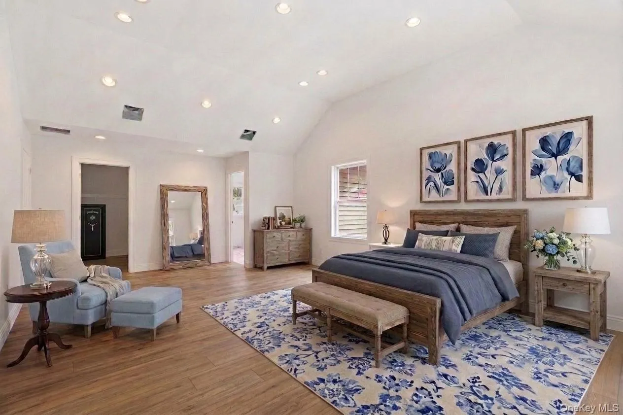 Virtually staged primary bedroom showcasing warm-stained hardwood floors, recessed lighting, and thoughtfully placed furnishings to illustrate the room’s scale, warmth, and finished potential. Virtually staged primary bedroom showcasing warm-stained hardwood floors, recessed lighting, and thoughtfully placed furnishings to illustrate the room’s scale, warmth, and finished potential.
