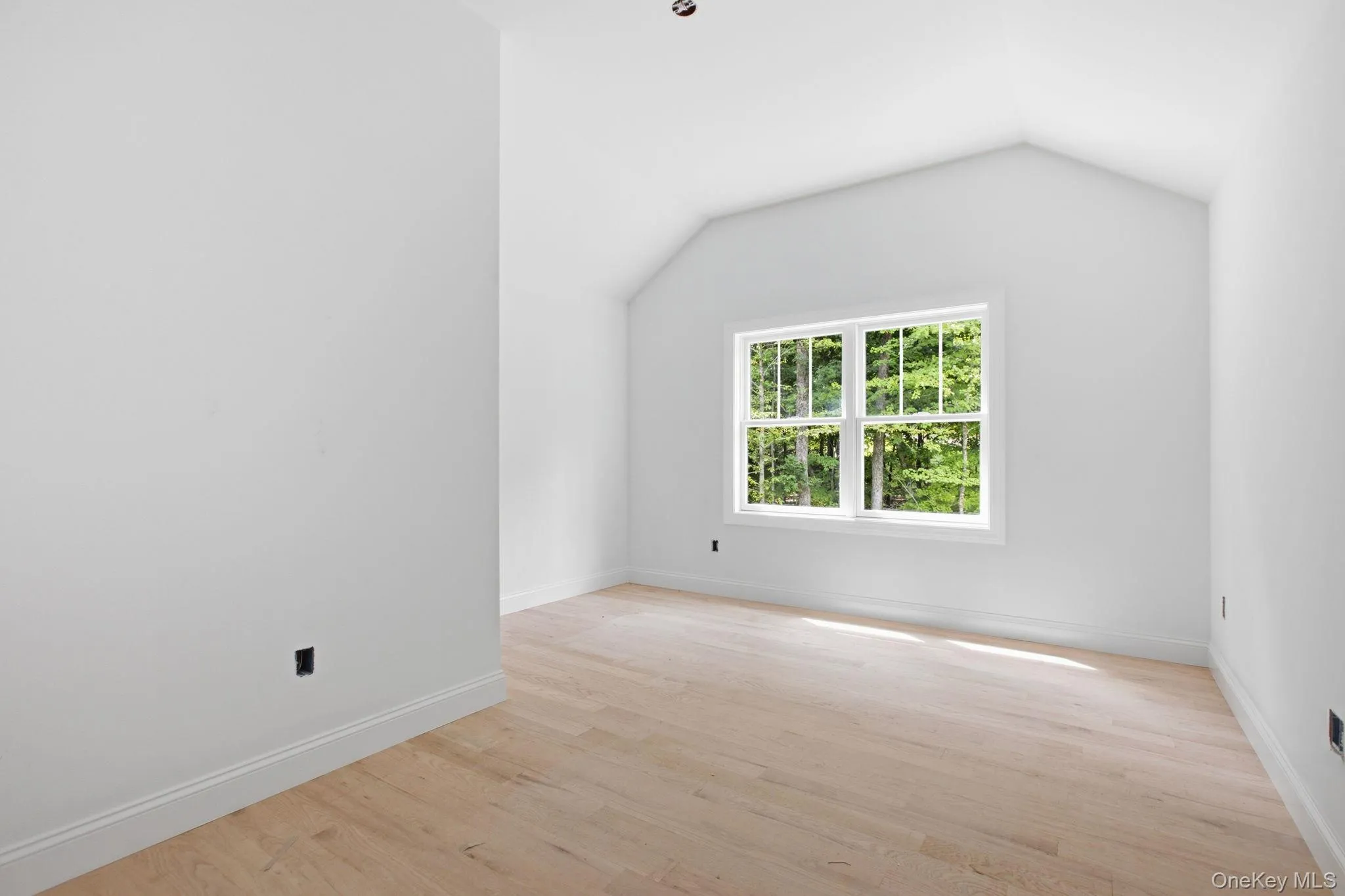 Inviting bedroom featuring high ceilings, hardwood floors, and a large closet, combining comfort with ample storage. Inviting bedroom featuring high ceilings, hardwood floors, and a large closet, combining comfort with ample storage.