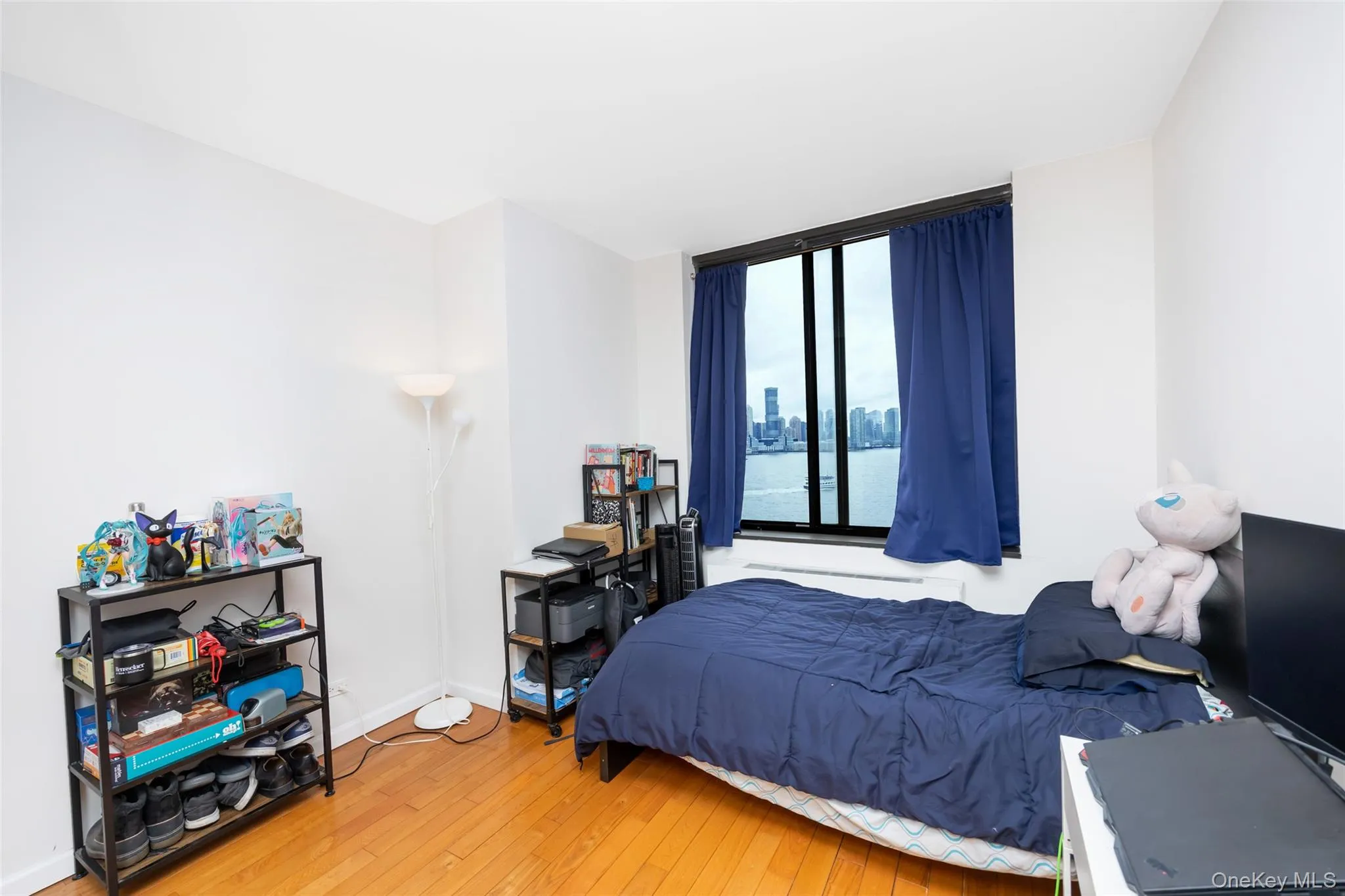 Bedroom with baseboards and wood-type flooring Bedroom with baseboards and wood-type flooring