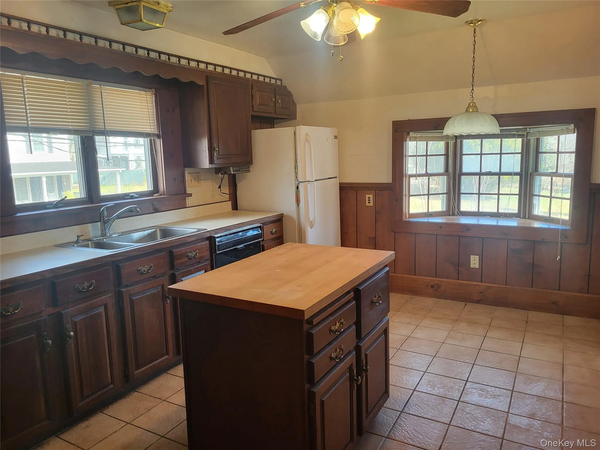 Kitchen with plenty of cabinets, tile floors, and ceiling fan Kitchen with plenty of cabinets, tile floors, and ceiling fan