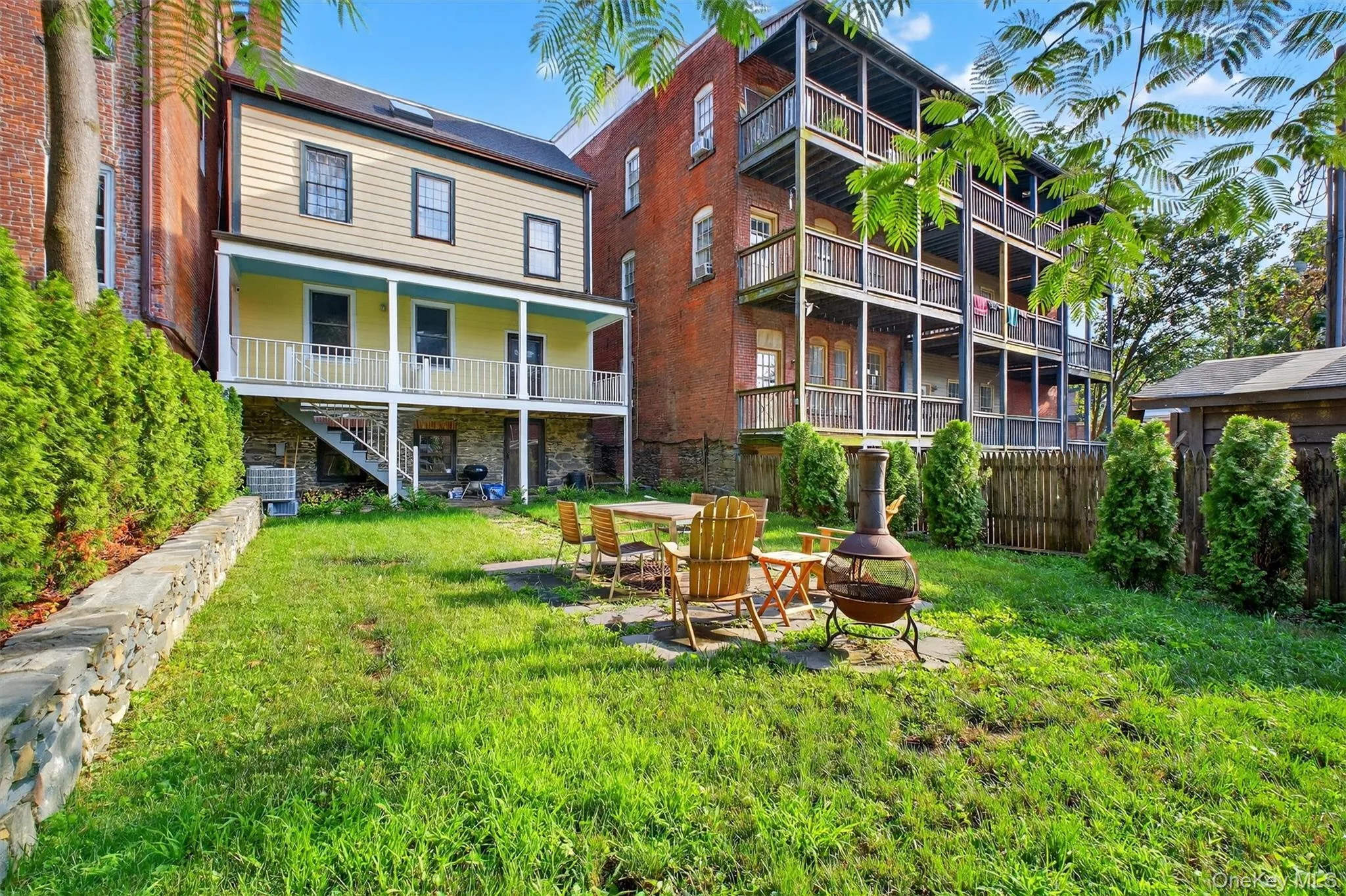 View of yard with an outdoor fire pit and stairway View of yard with an outdoor fire pit and stairway