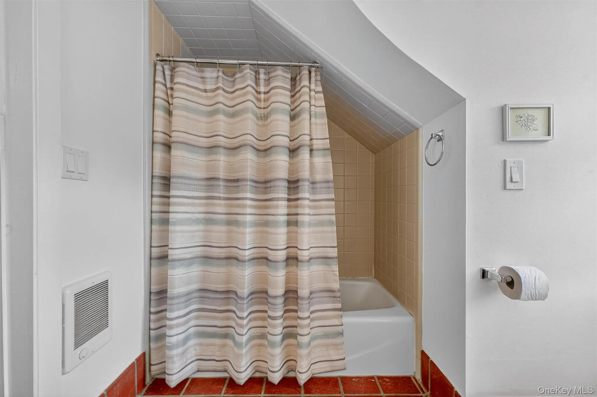 Full bath featuring vaulted ceiling, shower / bath combo with shower curtain, and heating unit Full bath featuring vaulted ceiling, shower / bath combo with shower curtain, and heating unit