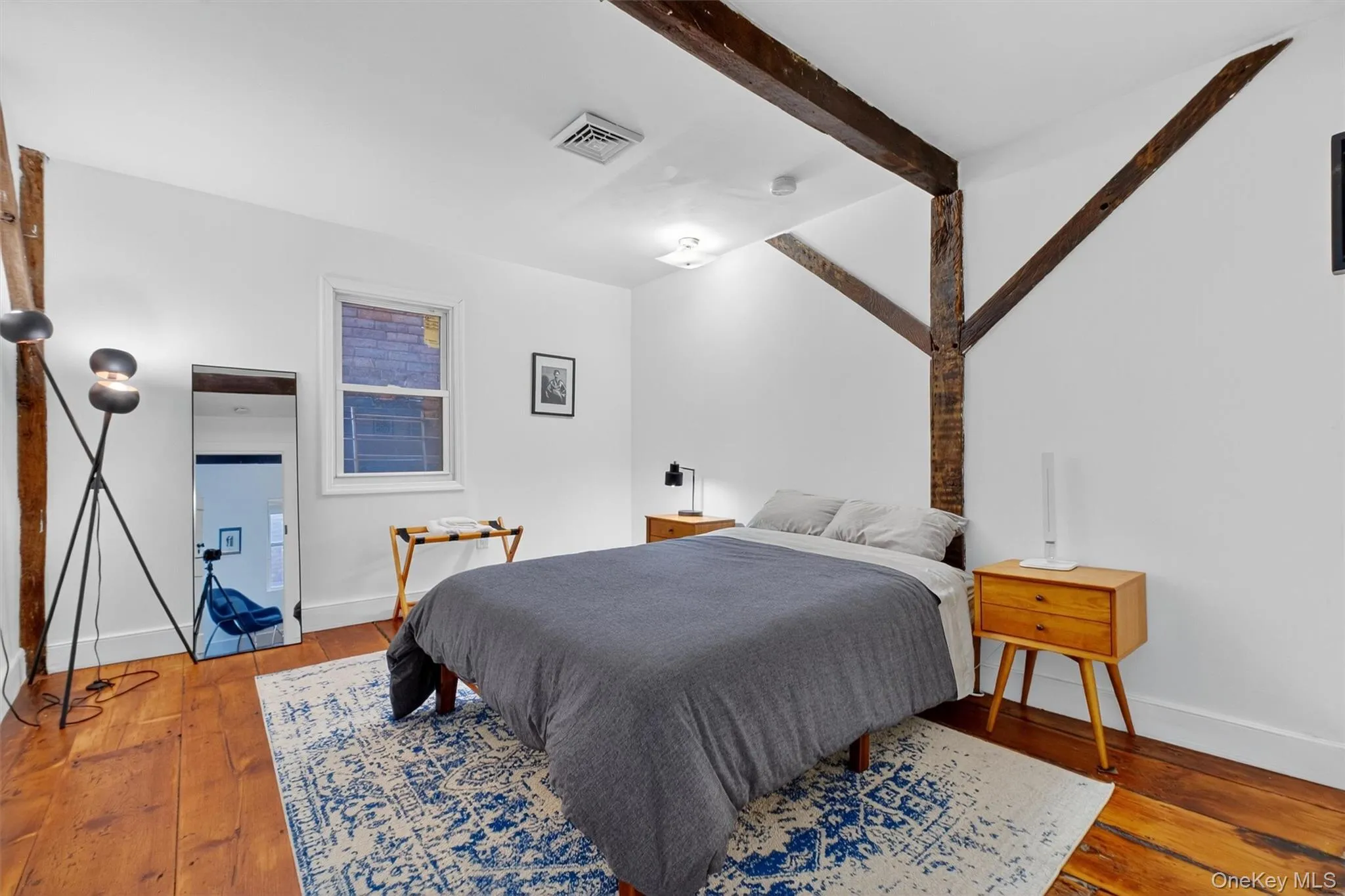 Bedroom featuring beam ceiling and wood-type flooring Bedroom featuring beam ceiling and wood-type flooring