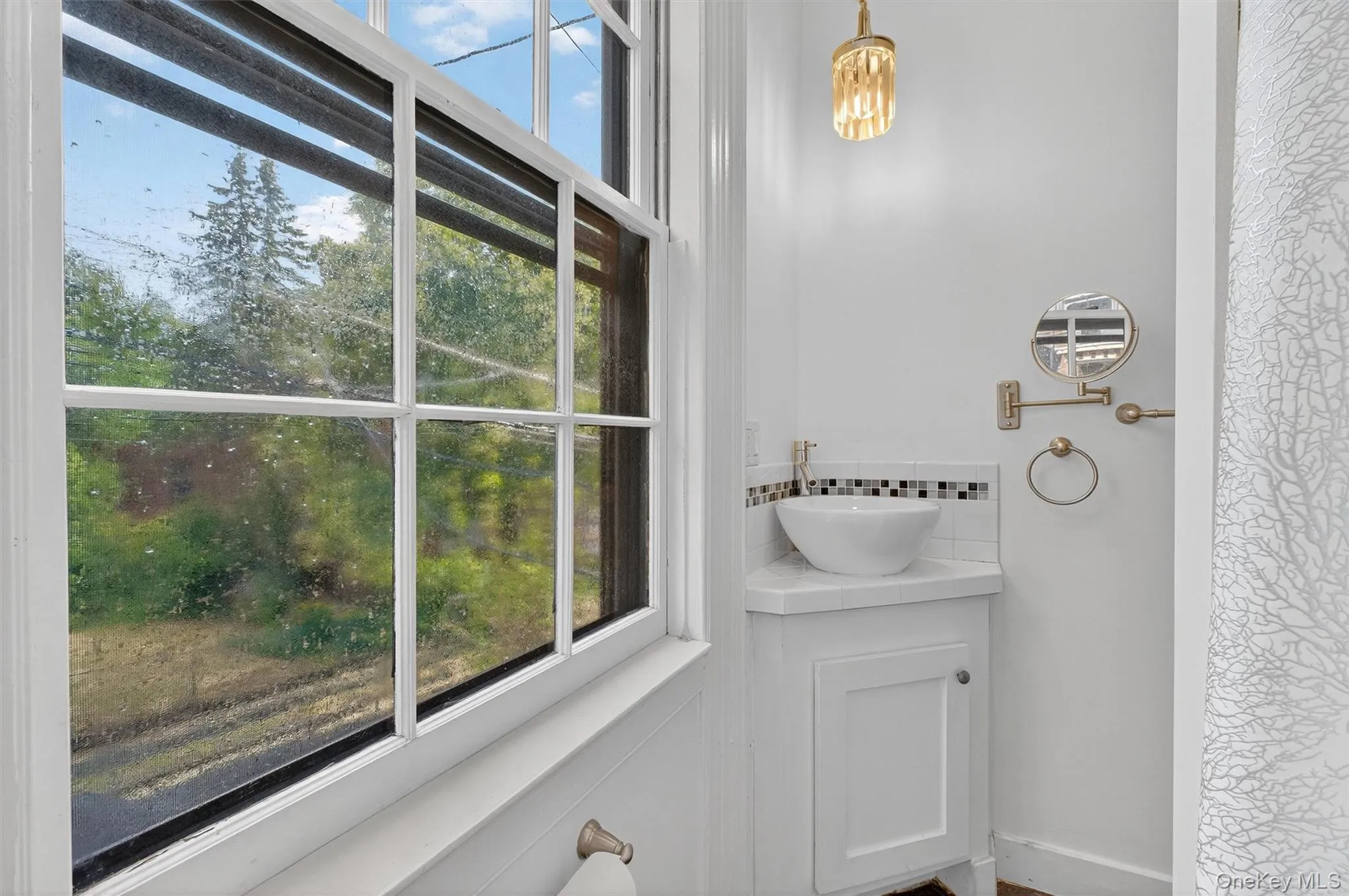 Bathroom with healthy amount of natural light and backsplash Bathroom with healthy amount of natural light and backsplash