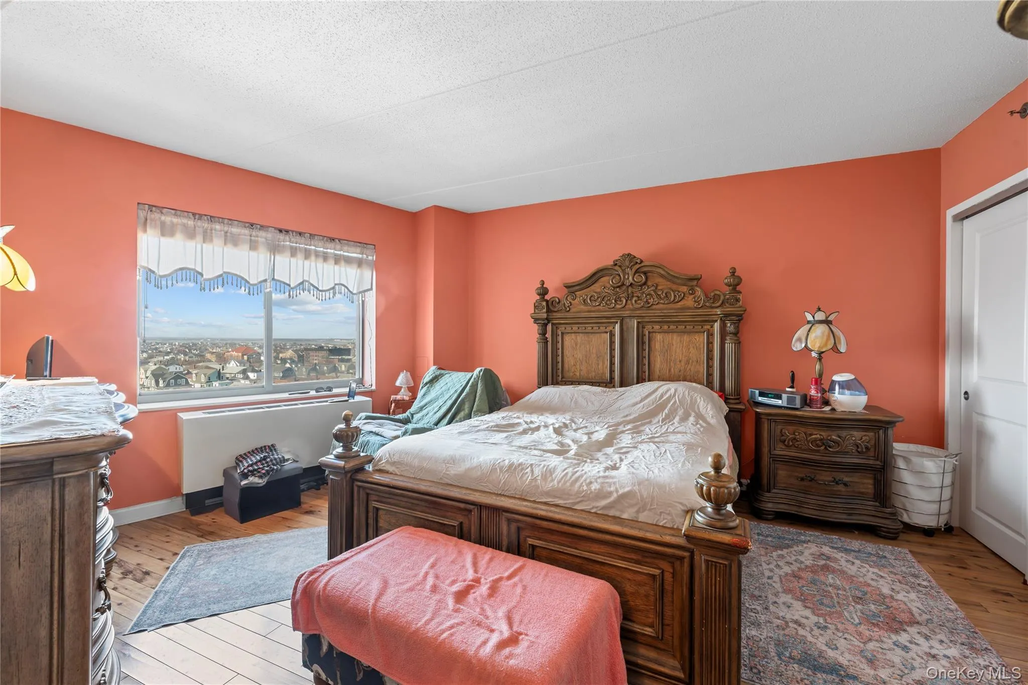 Expansive room featuring a large window, light-toned wood-finish flooring, Expansive room featuring a large window, light-toned wood-finish flooring,