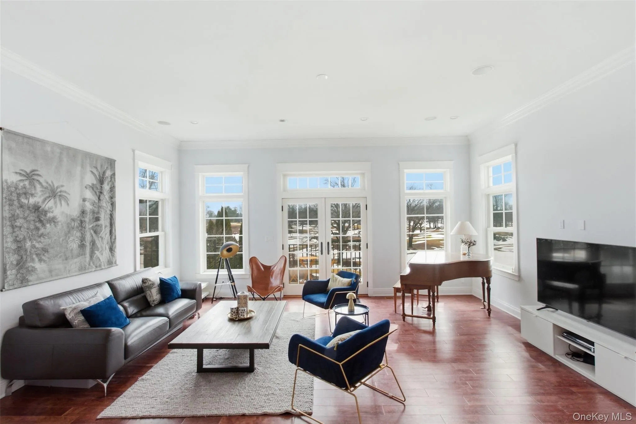 Sunken living room with floor to ceiling windows and door to access patio overlooking golf course Sunken living room with floor to ceiling windows and door to access patio overlooking golf course