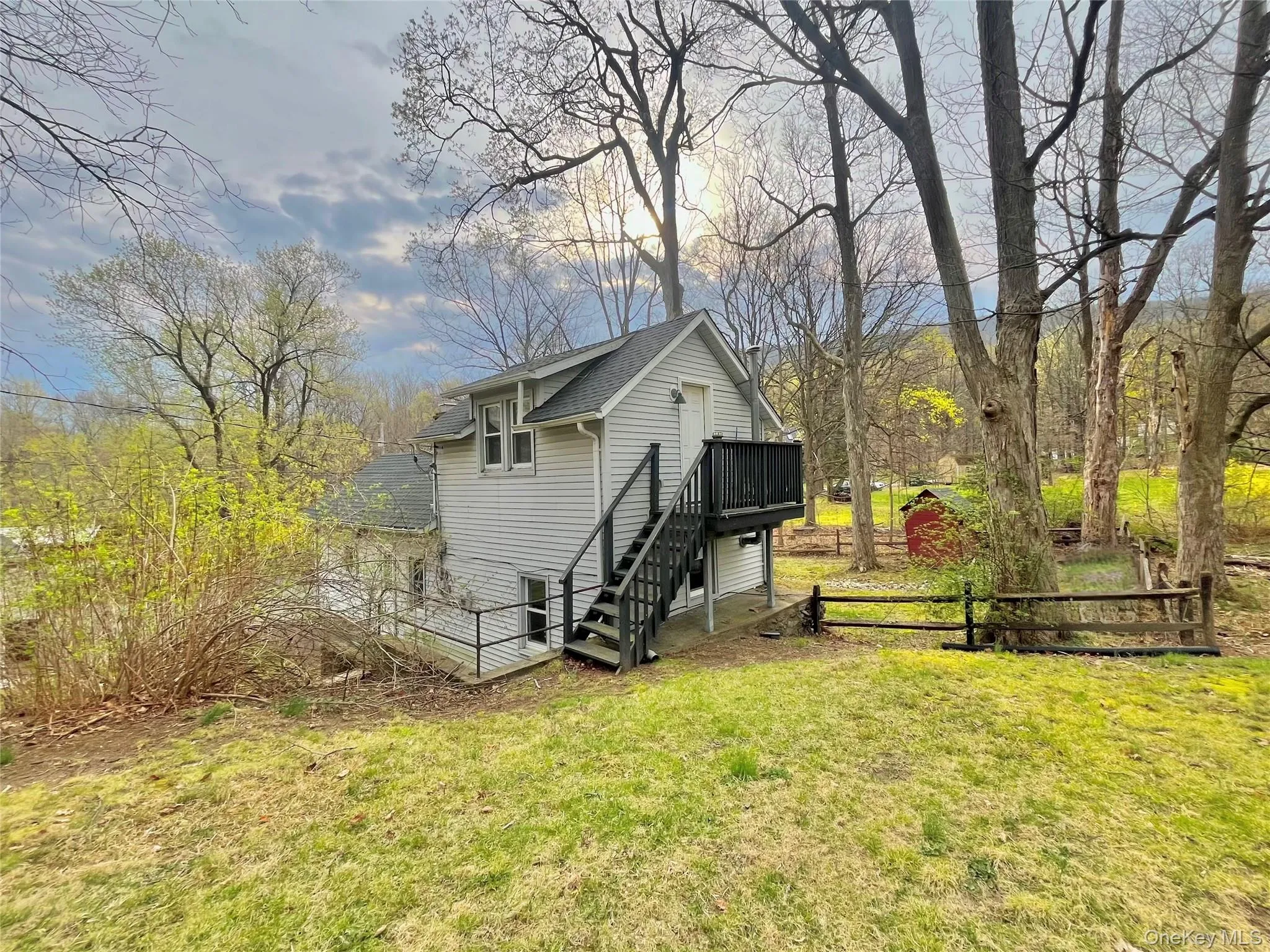 View of outbuilding featuring stairway and fence View of outbuilding featuring stairway and fence