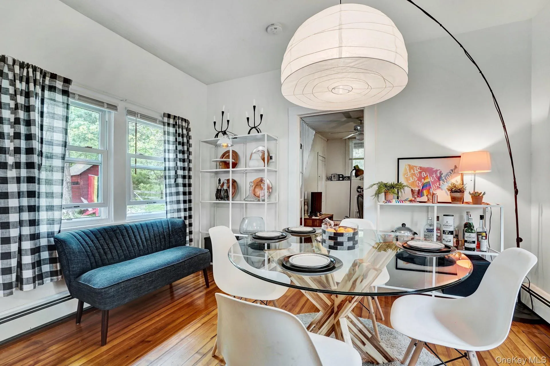 Dining area with a baseboard radiator, wood-type flooring, and ceiling fan Dining area with a baseboard radiator, wood-type flooring, and ceiling fan