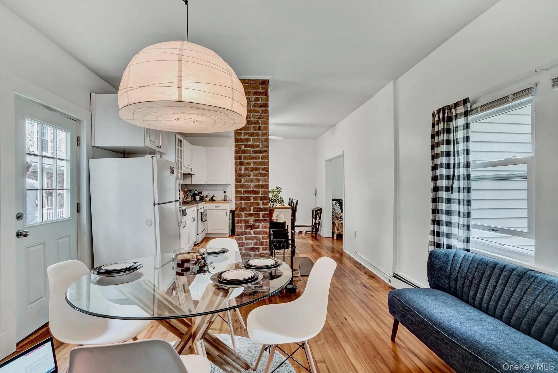 Dining area with a baseboard radiator and light wood-style flooring Dining area with a baseboard radiator and light wood-style flooring