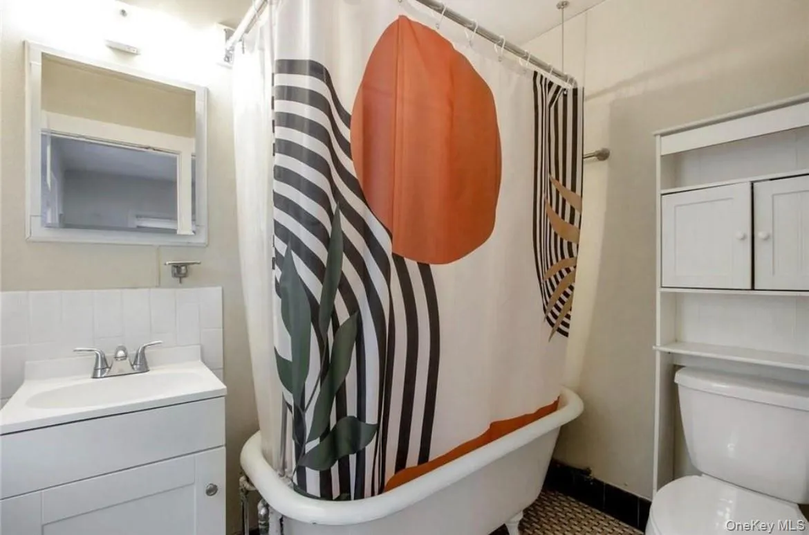 Full bathroom with toilet and vanity Full bathroom with toilet and vanity