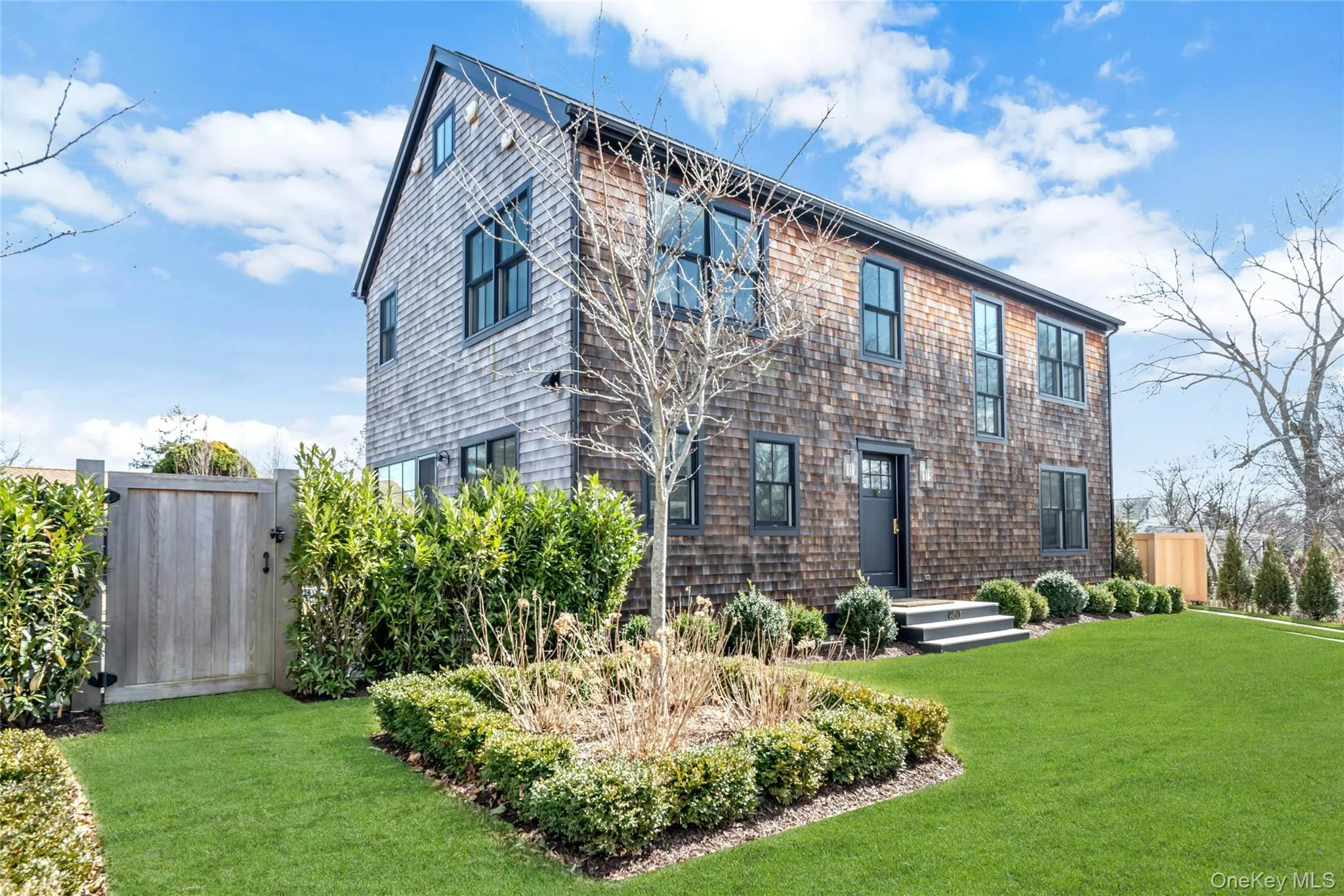 Front view of luxury 4-bedroom home for rent in New Suffolk, NY, featuring a walkable location near the waterfront and local North Fork favorites. Front view of luxury 4-bedroom home for rent in New Suffolk, NY, featuring a walkable location near the waterfront and local North Fork favorites.