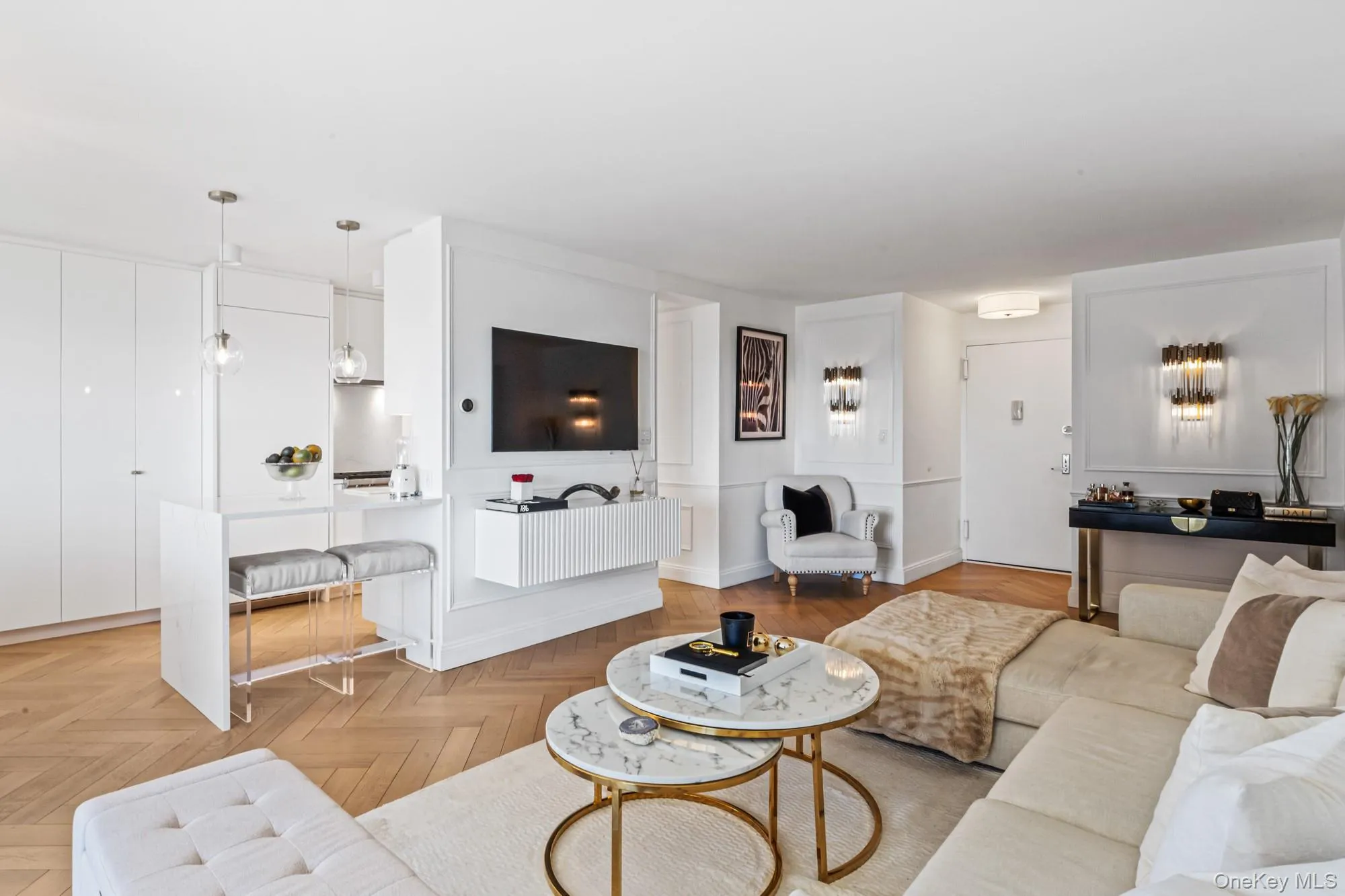Living Room featuring herringbone parquet flooring, suspended lighting, and a water view Living Room featuring herringbone parquet flooring, suspended lighting, and a water view