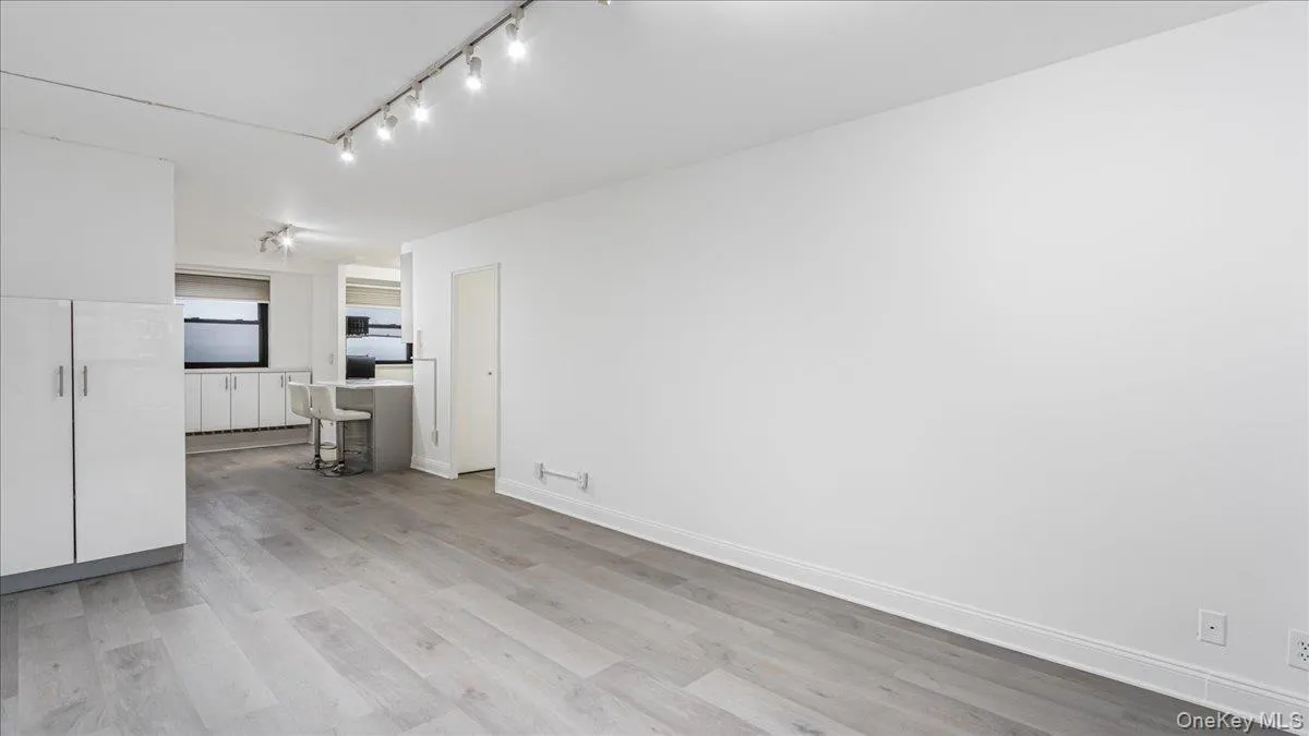 Spare room featuring light wood finished floors and baseboards Spare room featuring light wood finished floors and baseboards