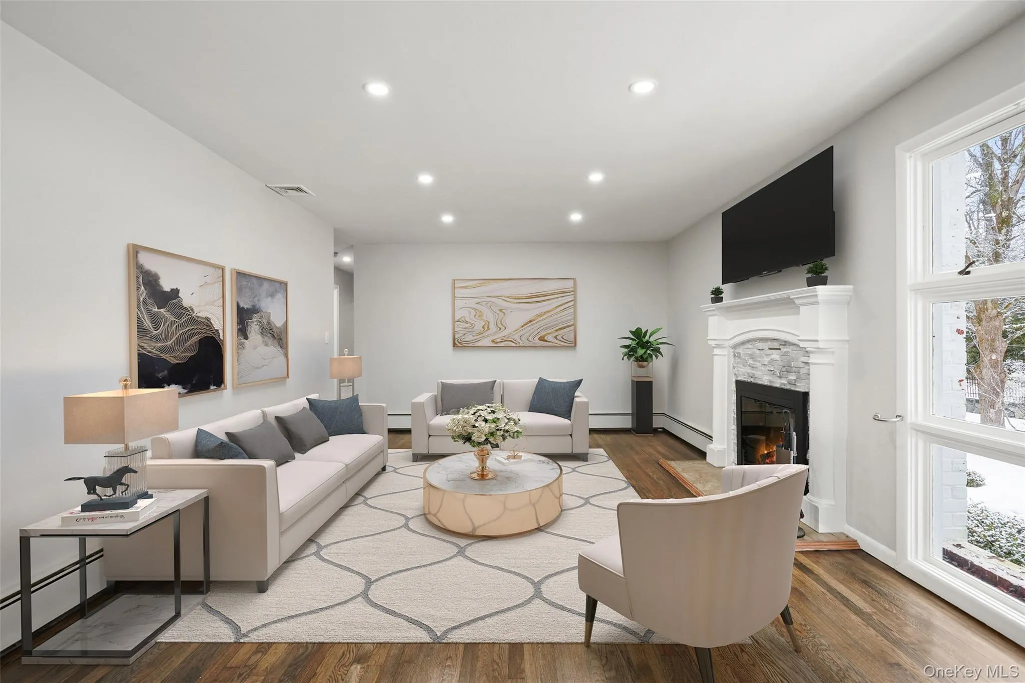 Living area with wood finished floors, a baseboard radiator, a glass covered fireplace, plenty of natural light, and recessed lighting. *Virtually Staged* Living area with wood finished floors, a baseboard radiator, a glass covered fireplace, plenty of natural light, and recessed lighting. *Virtually Staged*