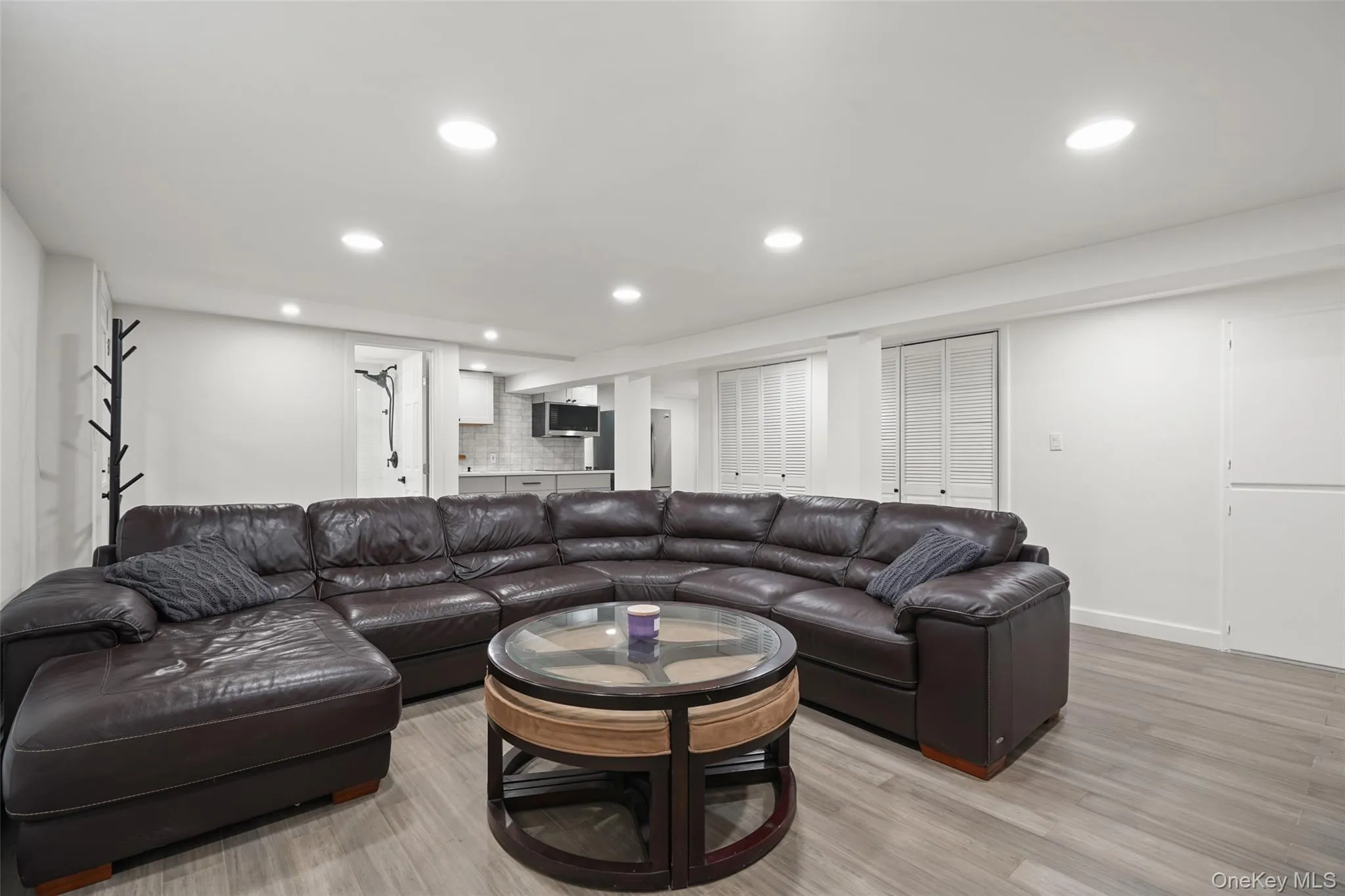Living area featuring light wood-type flooring and recessed lighting Living area featuring light wood-type flooring and recessed lighting