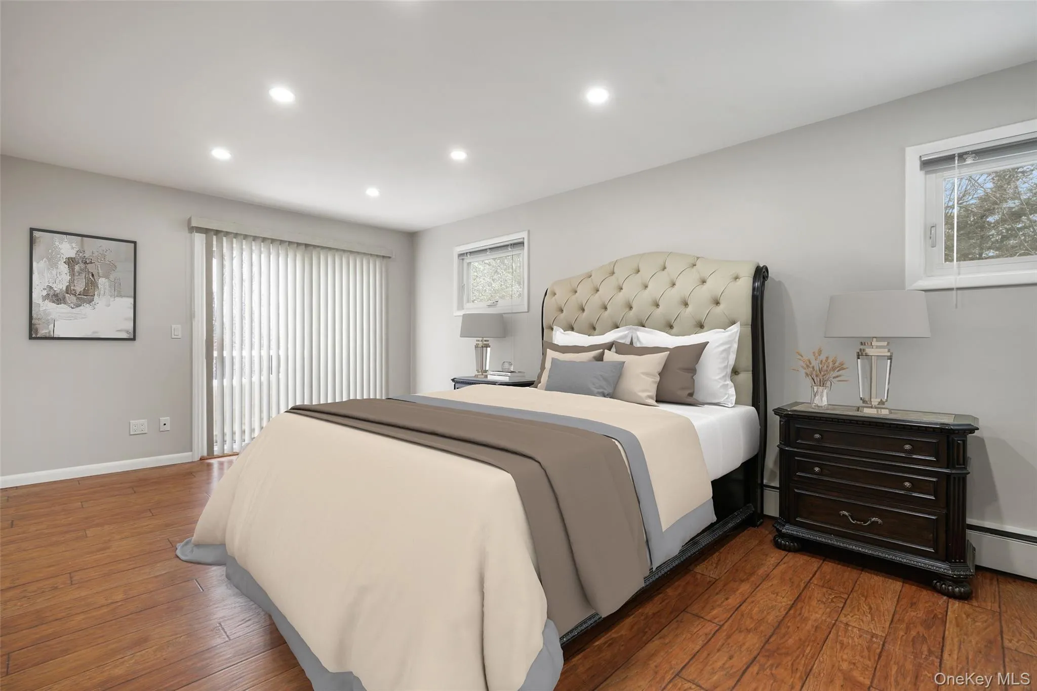 Bedroom with hardwood / wood-style flooring, multiple windows, recessed lighting, and private deck access. *Virtually Staged* Bedroom with hardwood / wood-style flooring, multiple windows, recessed lighting, and private deck access. *Virtually Staged*