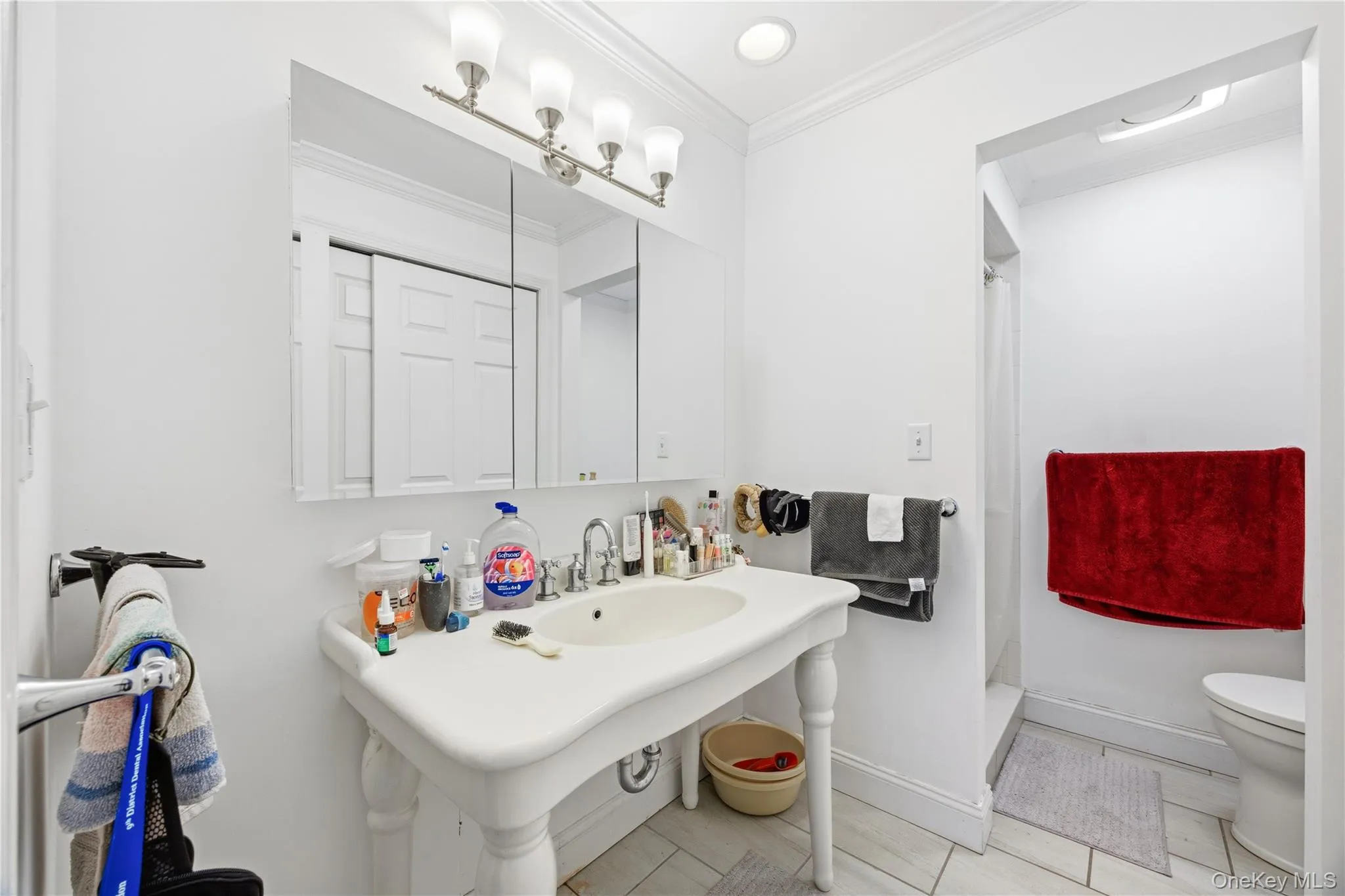 Bathroom with a shower stall, ornamental molding, and recessed lighting Bathroom with a shower stall, ornamental molding, and recessed lighting