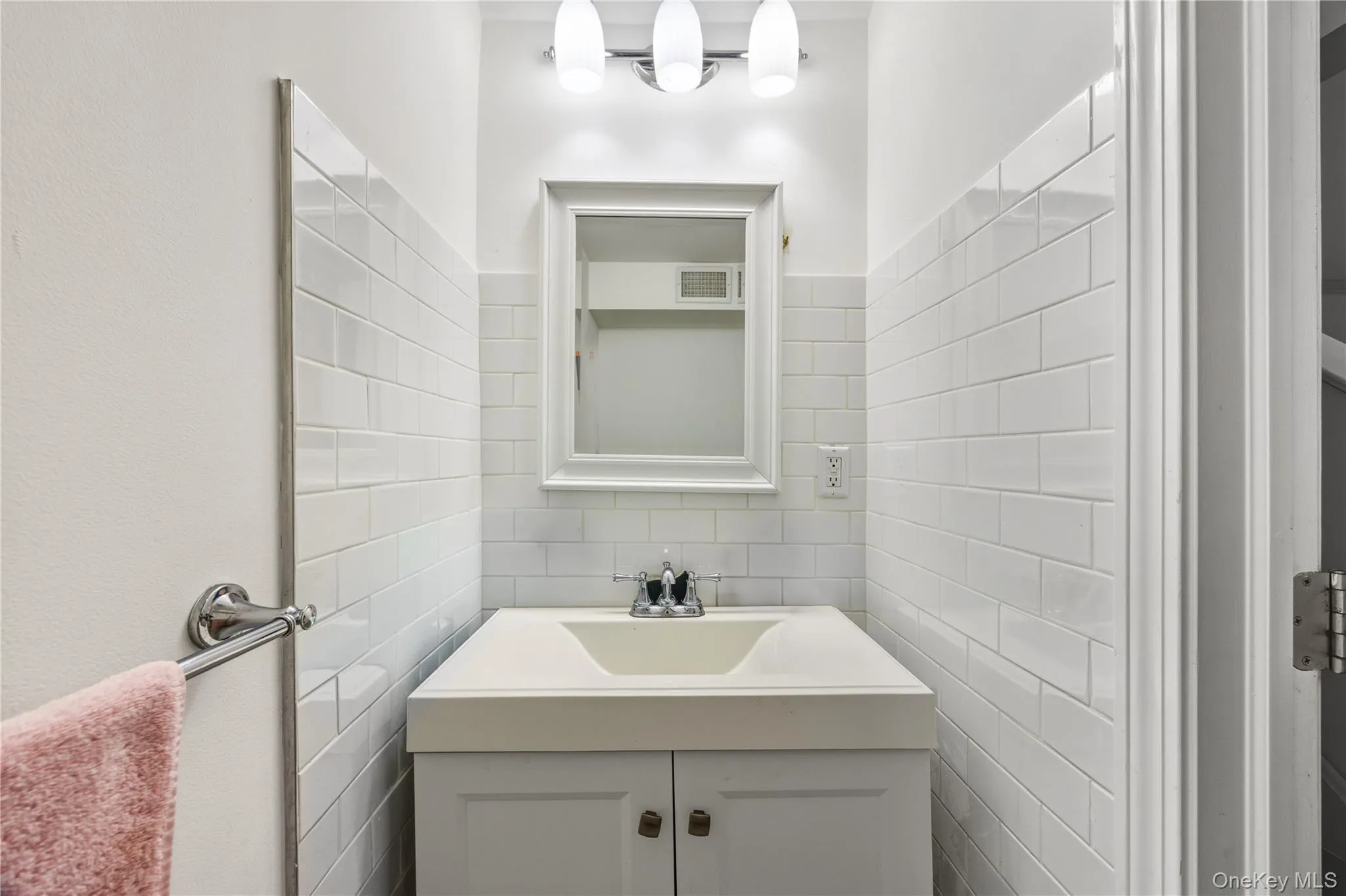 1/2 Bathroom featuring vanity and tile walls 1/2 Bathroom featuring vanity and tile walls
