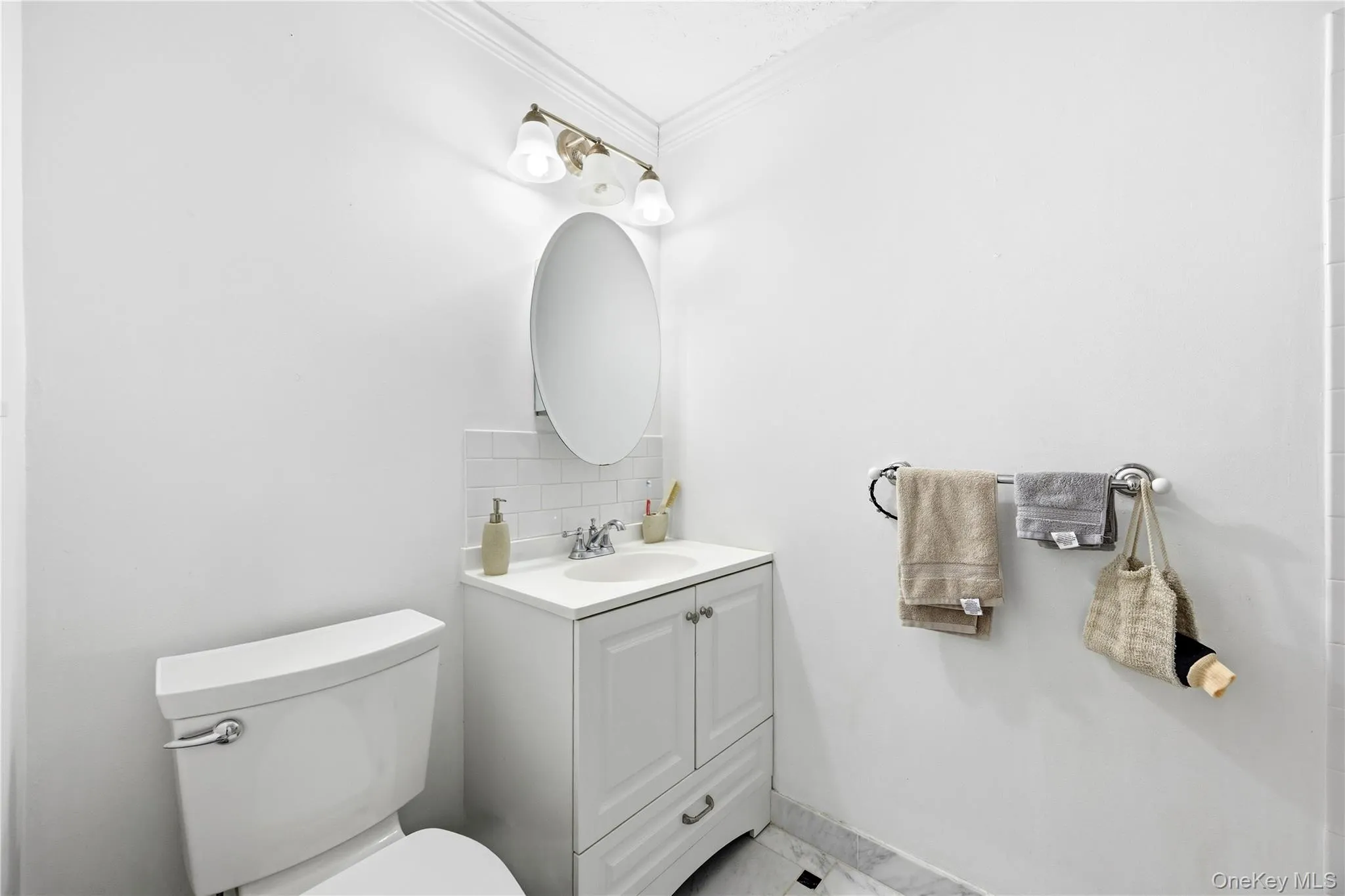 Bathroom with vanity, backsplash, and crown molding Bathroom with vanity, backsplash, and crown molding
