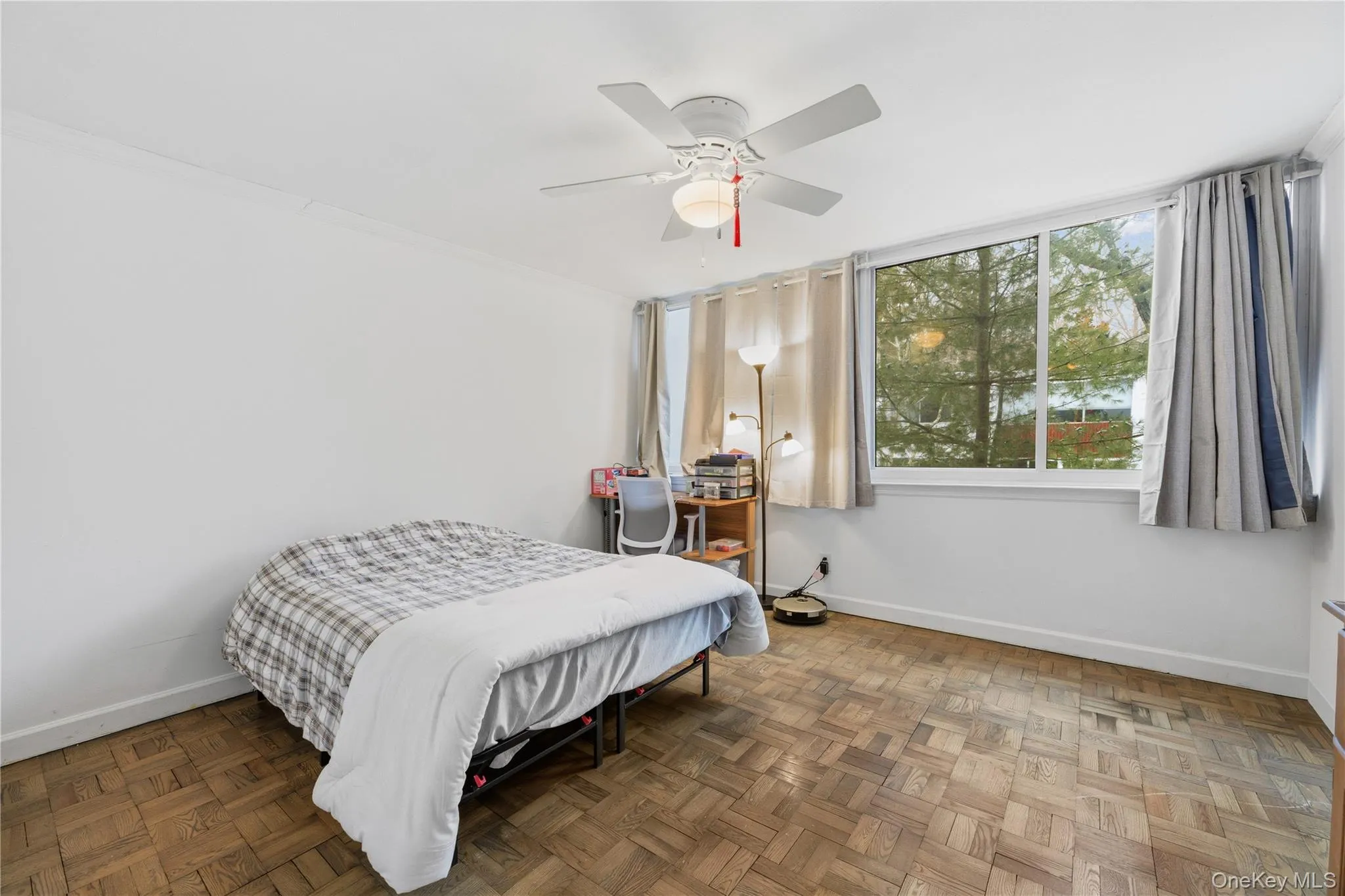 Bedroom featuring parquet flooring, ceiling fan, and ornamental molding Bedroom featuring parquet flooring, ceiling fan, and ornamental molding
