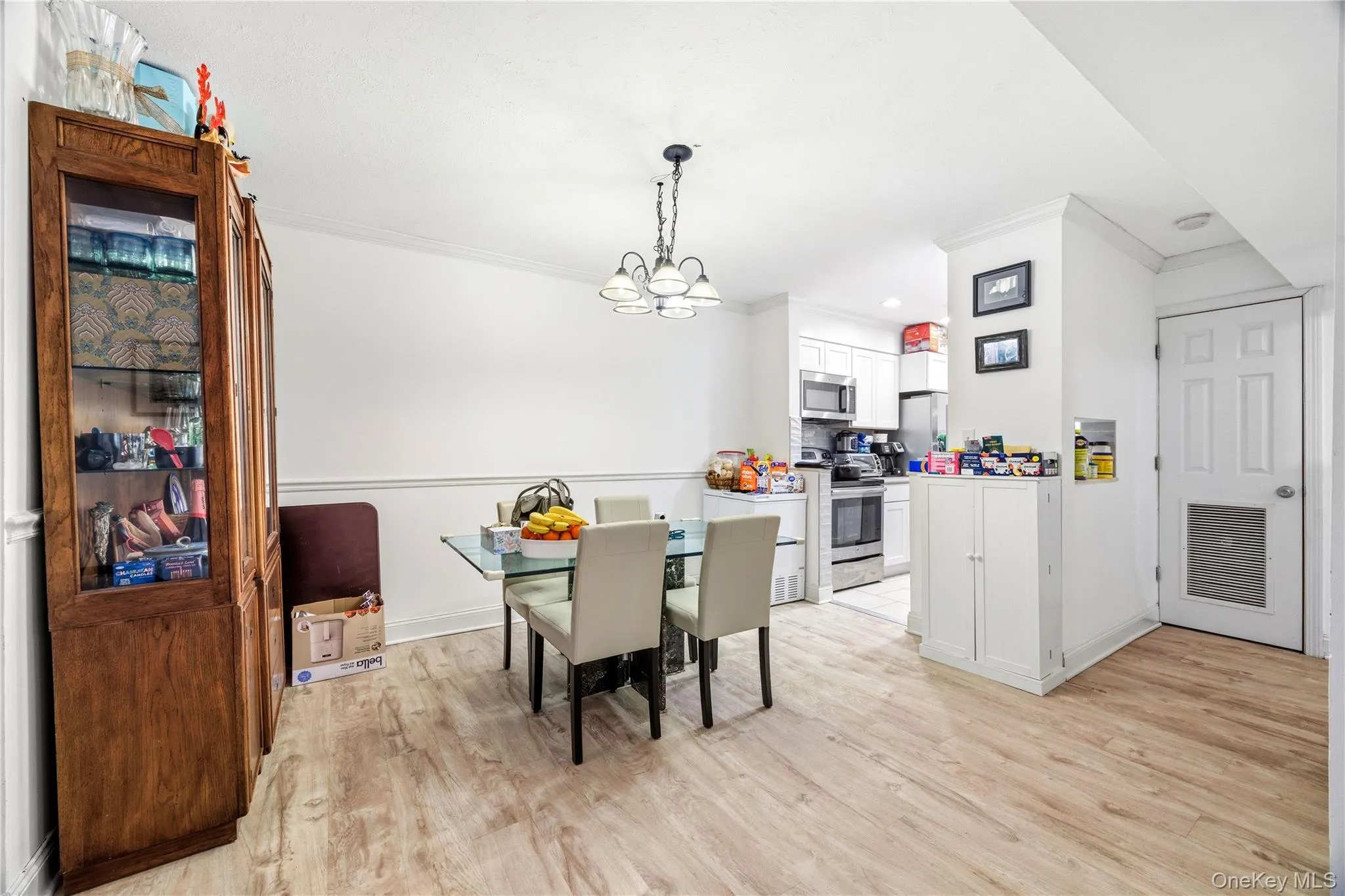 View of dining area and kitchen from the living room. View of dining area and kitchen from the living room.