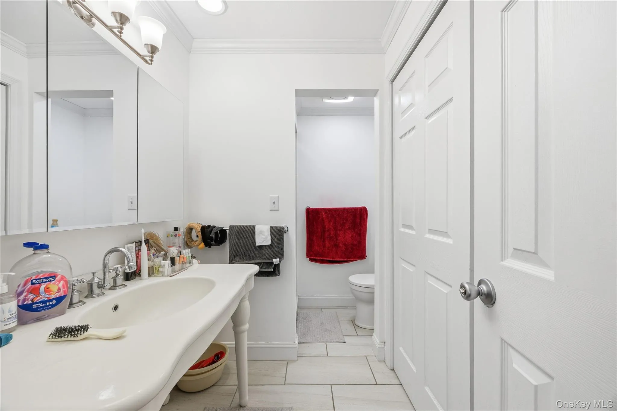 Bathroom with ornamental molding and toilet Bathroom with ornamental molding and toilet