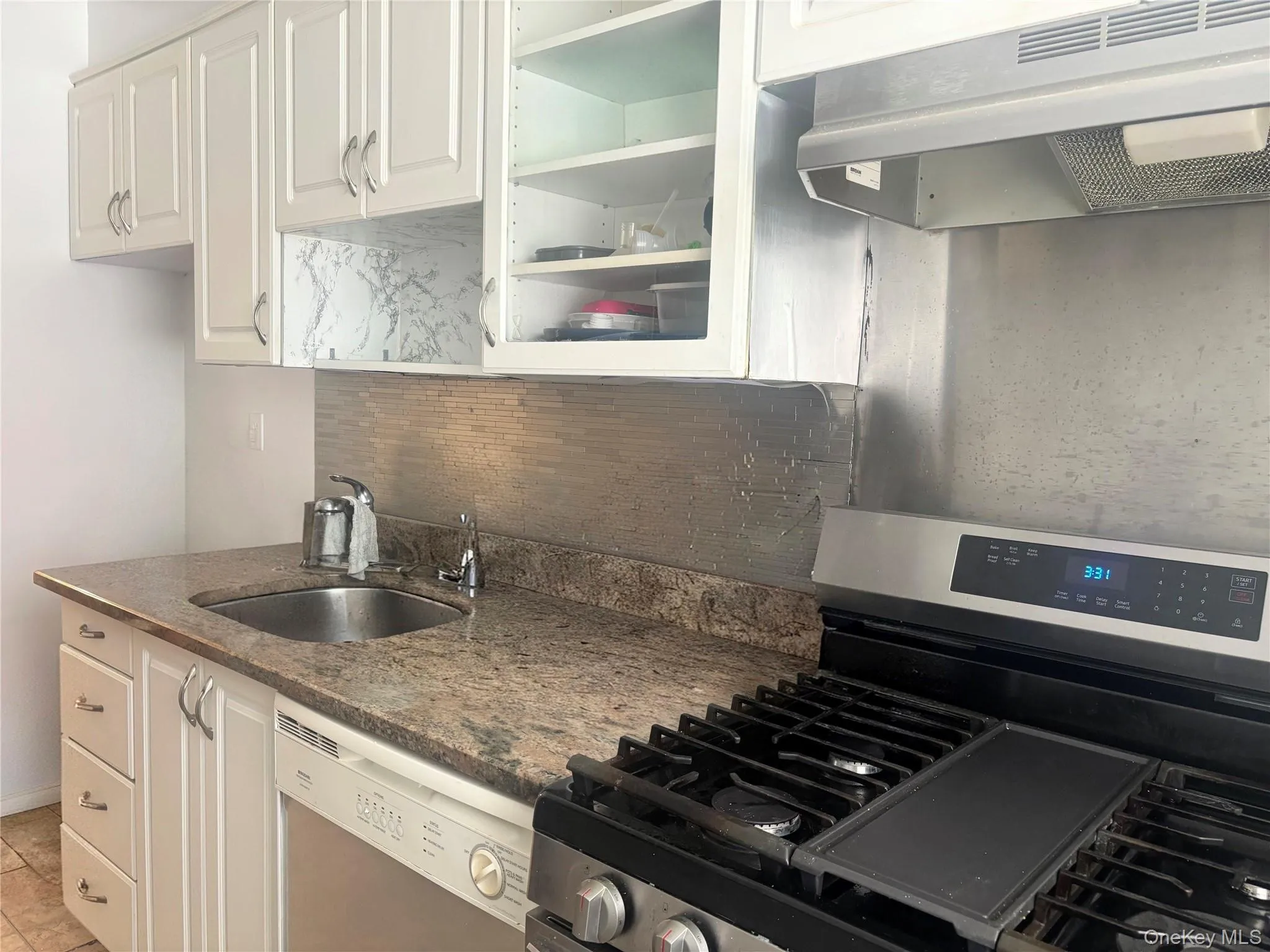 Galley kitchen with granite countertops and wood cabinets. Galley kitchen with granite countertops and wood cabinets.