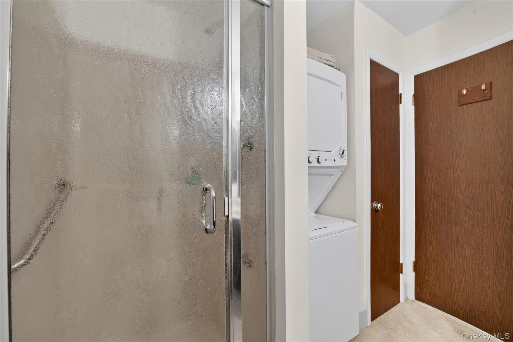 Hall bathroom includes a shower stall, washer/dryer & a linen closet. Hall bathroom includes a shower stall, washer/dryer & a linen closet.