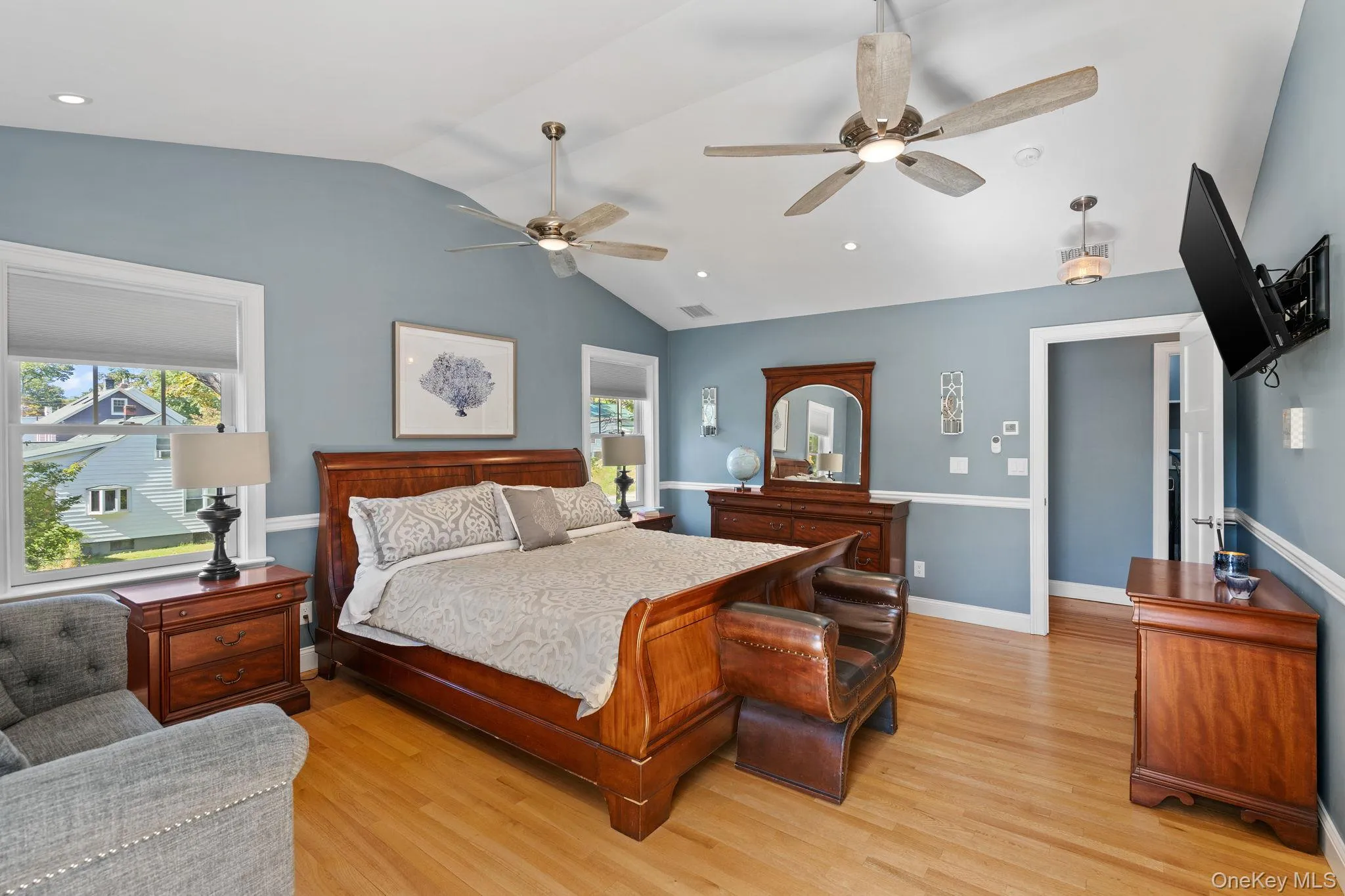 Bedroom featuring lofted ceiling, light wood finished floors, recessed lighting, and a ceiling fan Bedroom featuring lofted ceiling, light wood finished floors, recessed lighting, and a ceiling fan