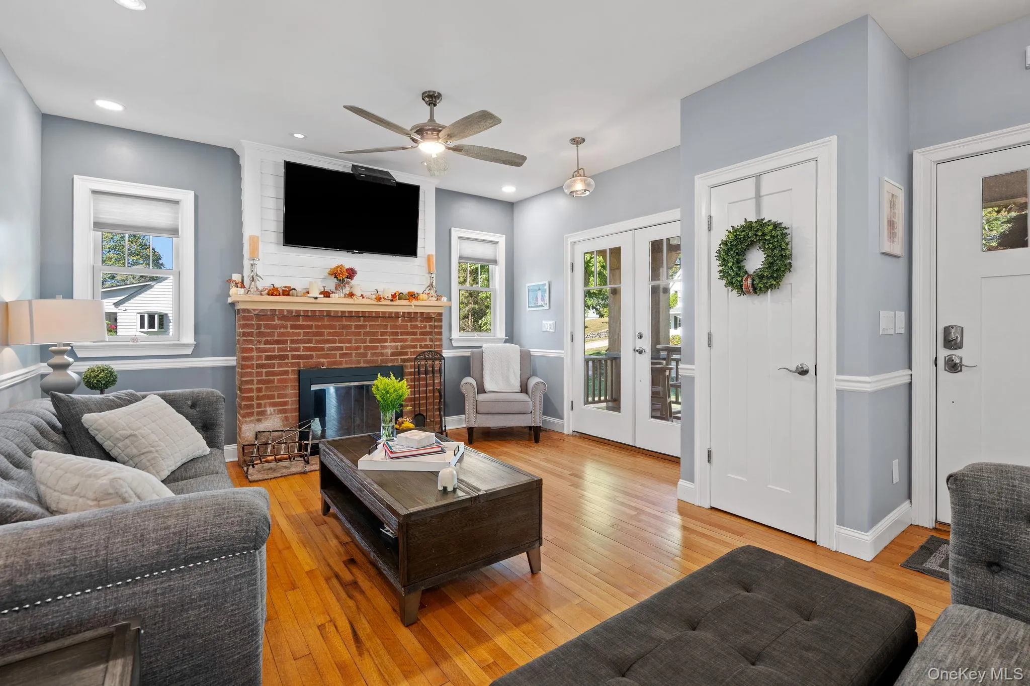 Living area with french doors, light wood-style flooring, plenty of natural light, and recessed lighting Living area with french doors, light wood-style flooring, plenty of natural light, and recessed lighting
