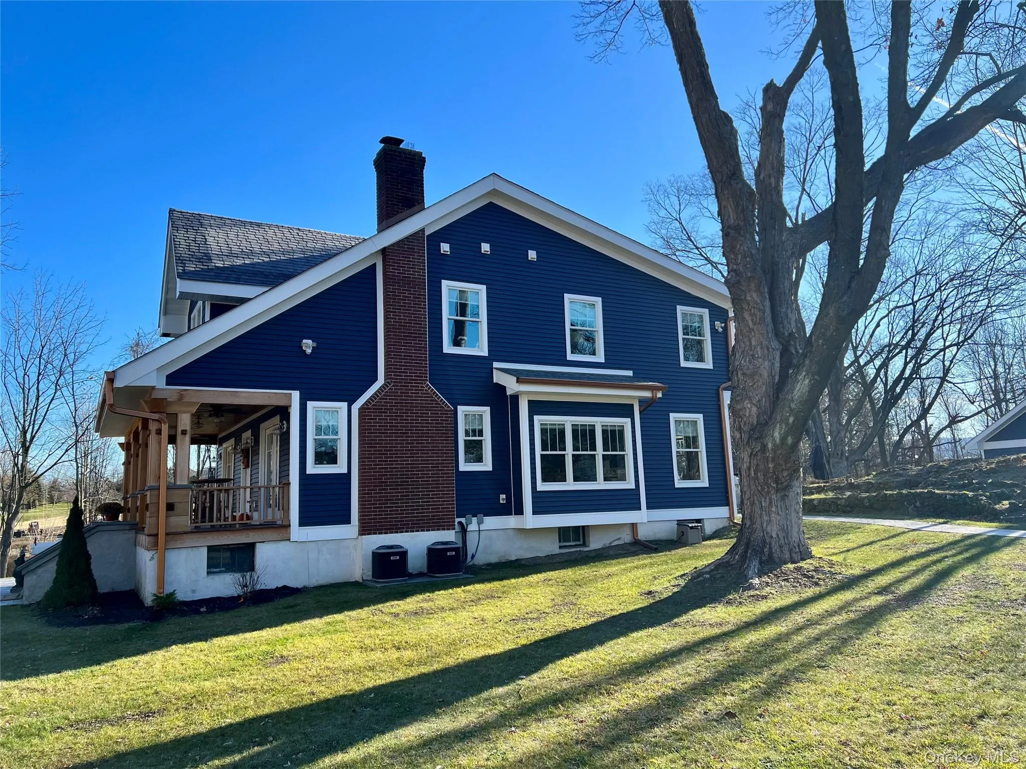 Rear view of house with a yard and a chimney Rear view of house with a yard and a chimney