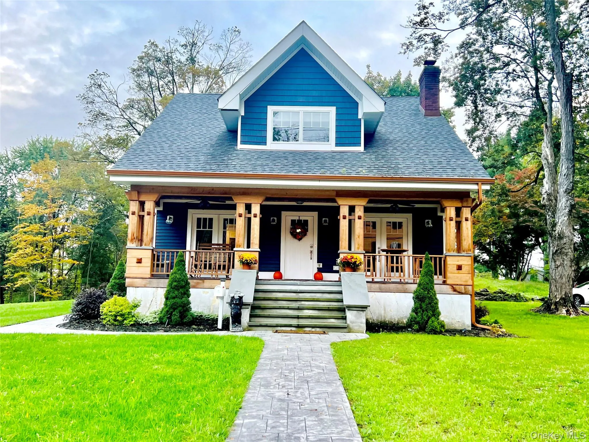 View of front of house featuring a front lawn, a porch, and roof with shingles View of front of house featuring a front lawn, a porch, and roof with shingles
