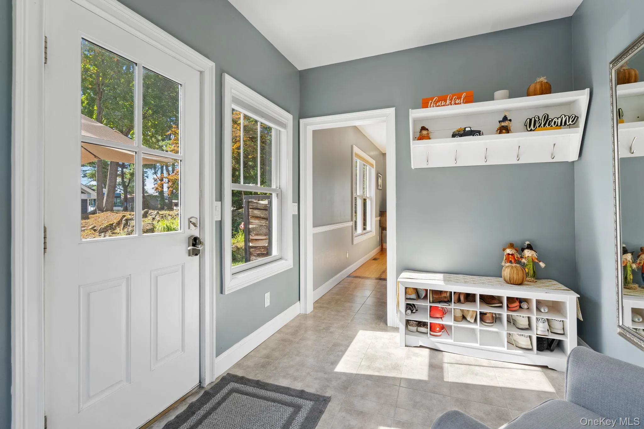 Mudroom with light tile patterned floors and baseboards Mudroom with light tile patterned floors and baseboards