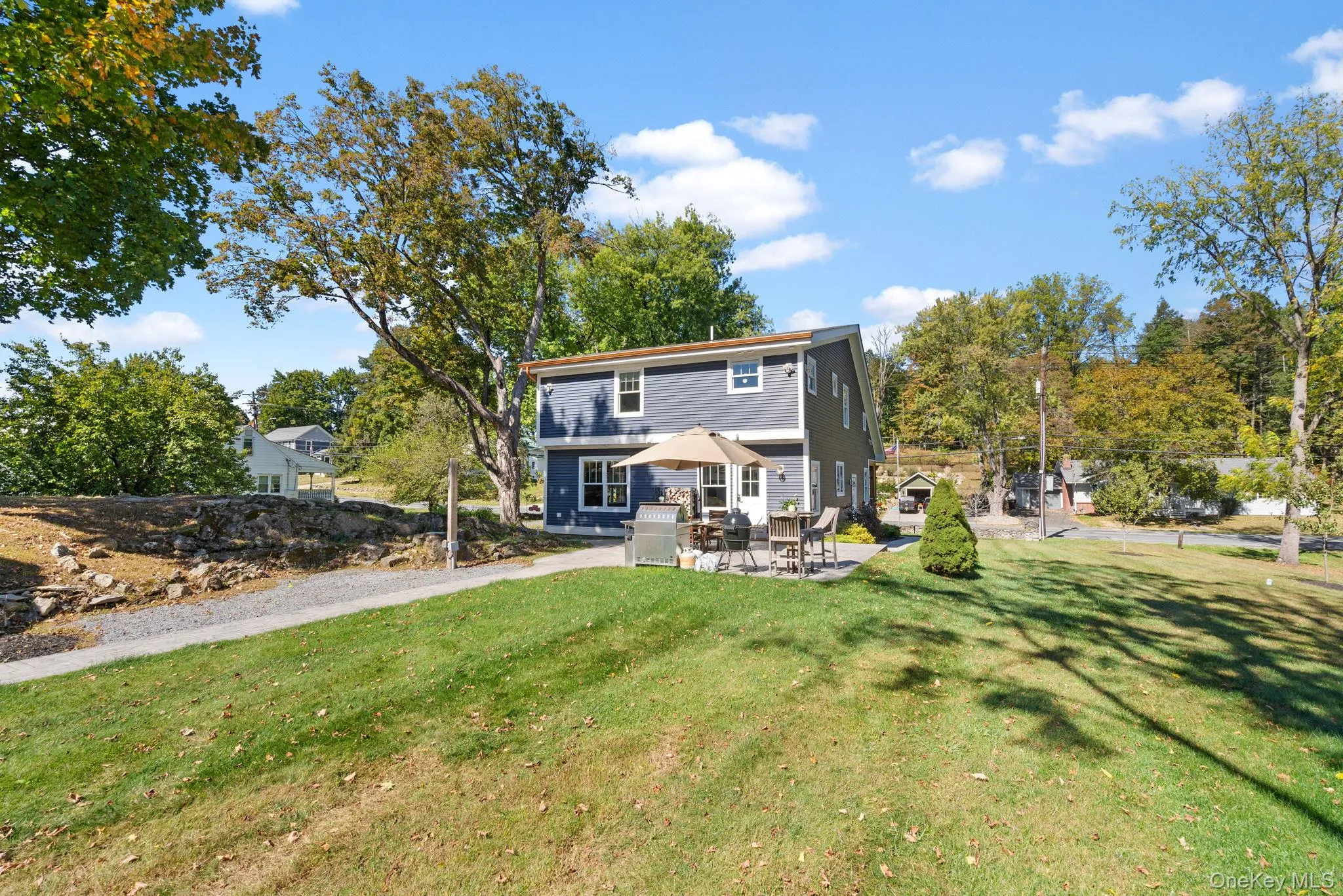 Back of property featuring a patio area and a lawn Back of property featuring a patio area and a lawn