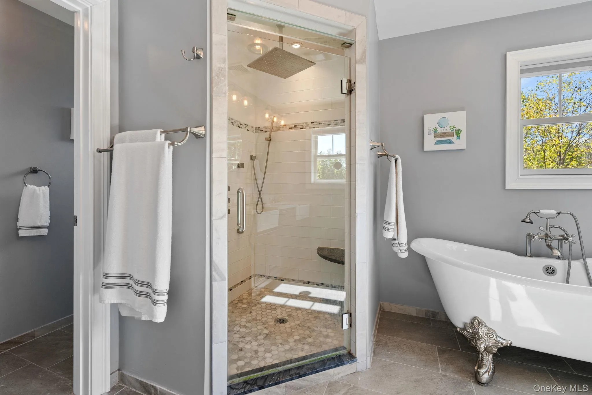 Bathroom featuring a shower stall, a soaking tub, and tile patterned floors Bathroom featuring a shower stall, a soaking tub, and tile patterned floors
