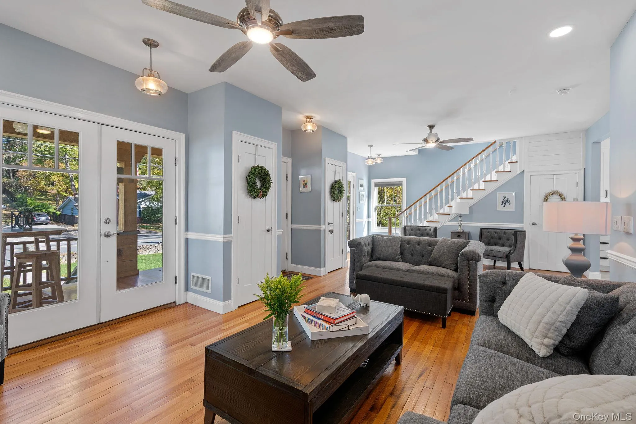 Living area featuring hardwood / wood-style flooring, stairs, french doors, ceiling fan, and recessed lighting Living area featuring hardwood / wood-style flooring, stairs, french doors, ceiling fan, and recessed lighting