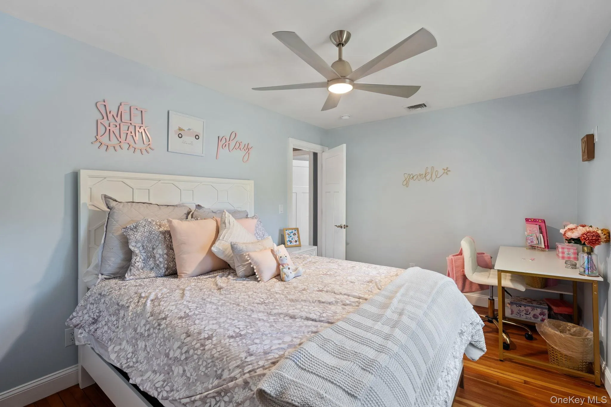Bedroom featuring wood finished floors and a ceiling fan Bedroom featuring wood finished floors and a ceiling fan