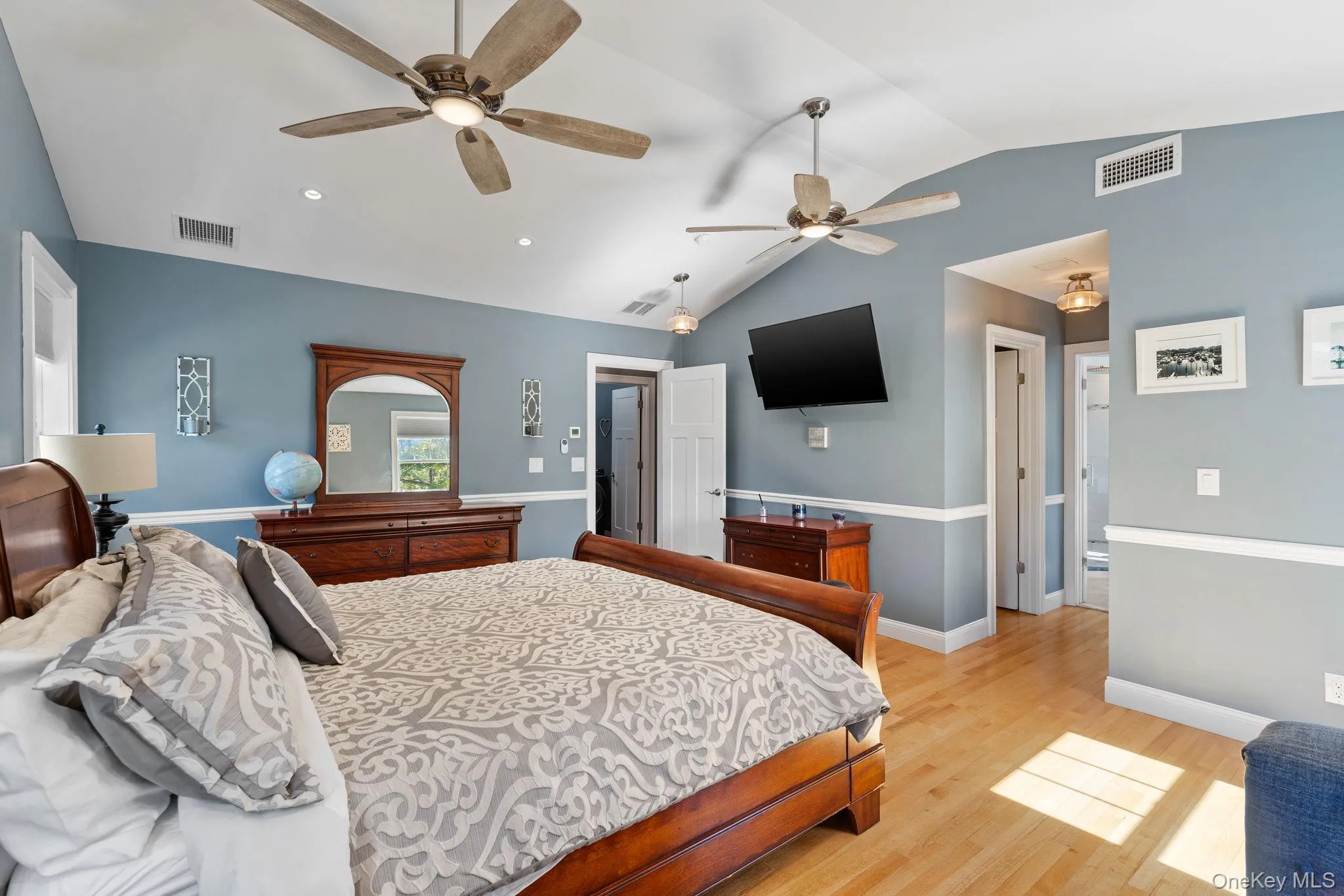 Bedroom featuring lofted ceiling, light wood-style floors, recessed lighting, and a ceiling fan Bedroom featuring lofted ceiling, light wood-style floors, recessed lighting, and a ceiling fan