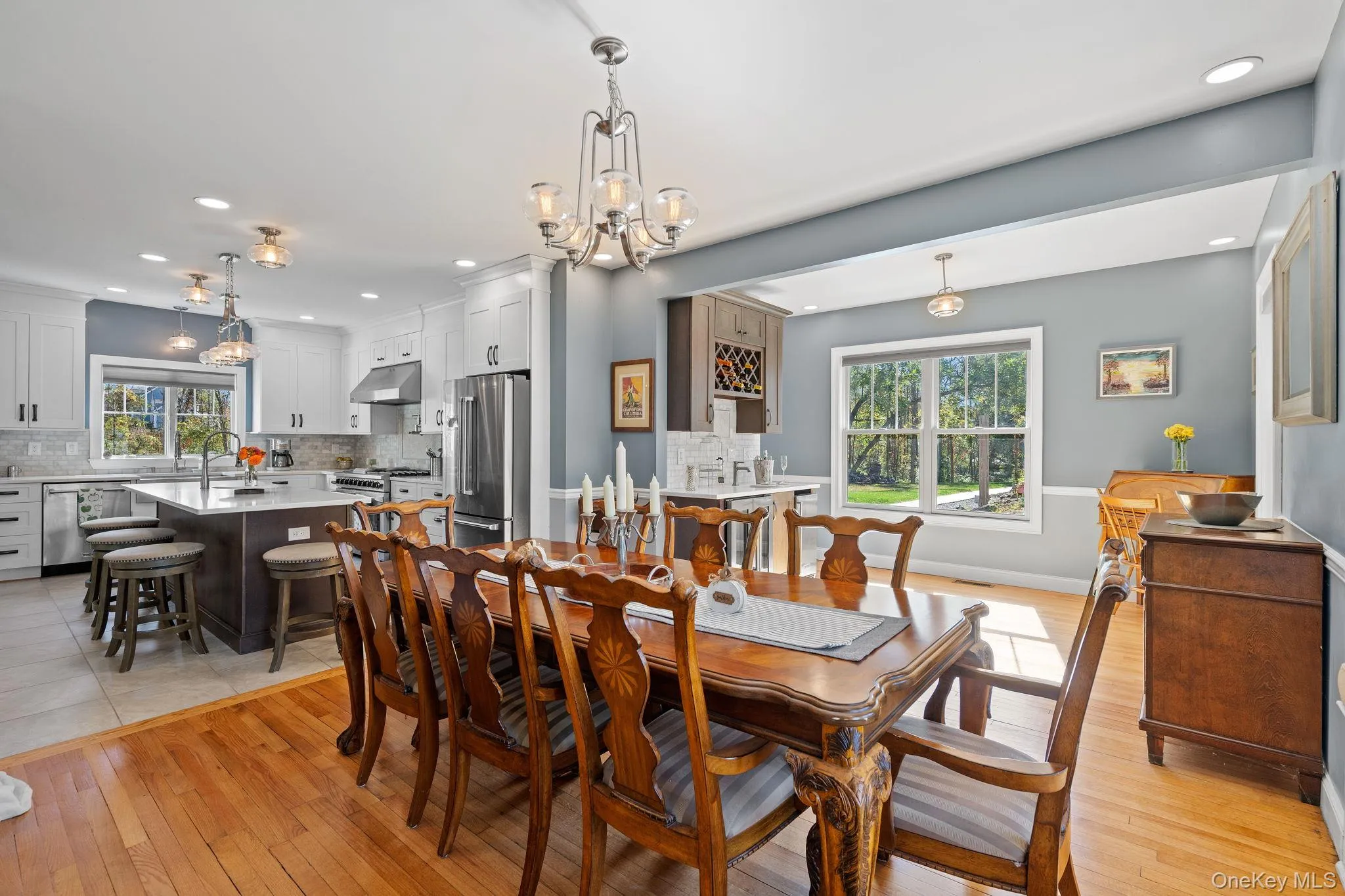 Dining area with light wood finished floors, a chandelier, and recessed lighting Dining area with light wood finished floors, a chandelier, and recessed lighting